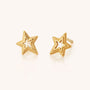 Stellar Starburst Stud Earrings in gold feature an open-center celestial design and are displayed on a plain, light background.