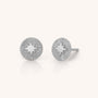The Shining Star Stud Earrings are crafted in sterling silver with a central raised starburst design, surrounded by engraved radiating lines.