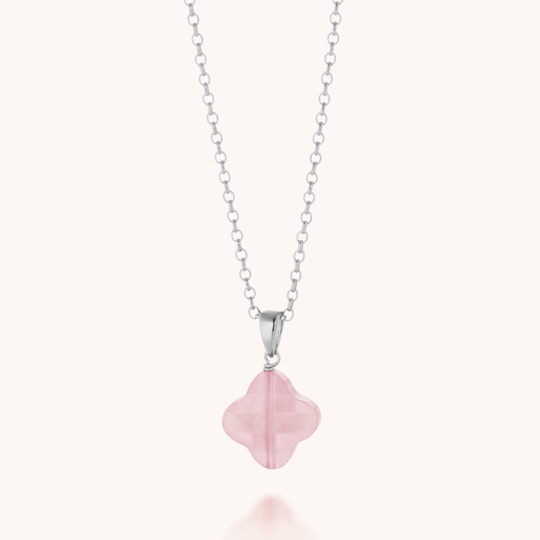 The Gem Clover Necklace showcases a light pink gemstone clover pendant on an eco-silver chain, beautifully displayed against a plain white background.