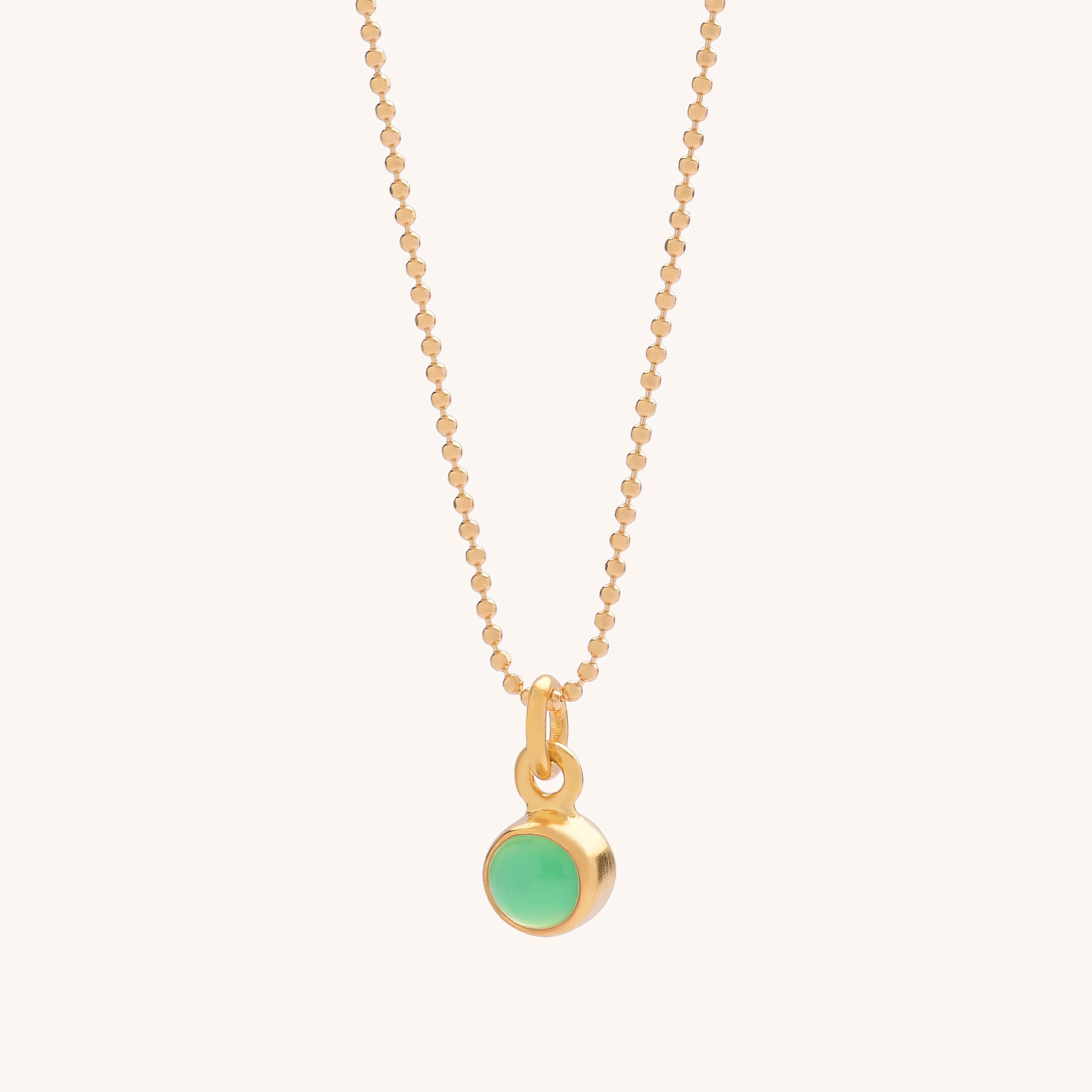Gem Dot Birthstone Necklace May: gold beaded chain with a small round natural Chrysoprase gemstone pendant in a gold bezel, known for healing properties, displayed on a plain light background.