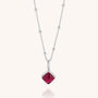 The Diamond Birthstone Necklace is a silver chain with small beads, featuring a square deep red natural gemstone pendant framed in silver—a stunning personalized birthday gift shown on a light background.