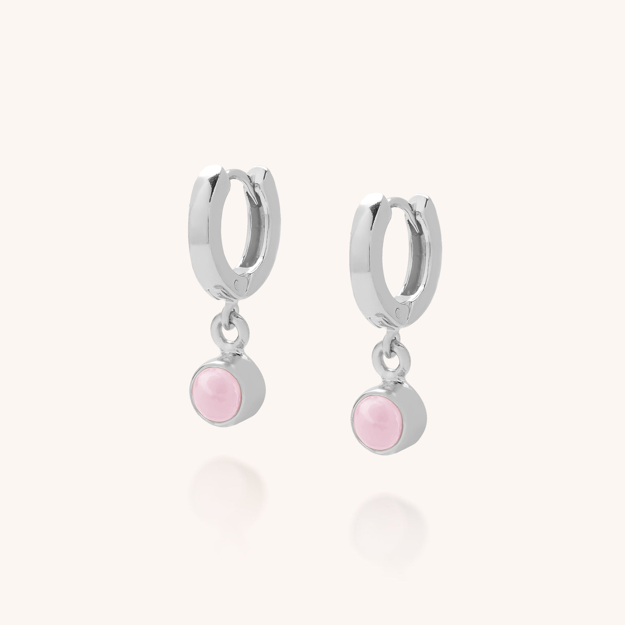 Gem Hoop Earrings - October Birthstone: Silver hoops with small, round Pink Opal dangles, set against a simple light background.