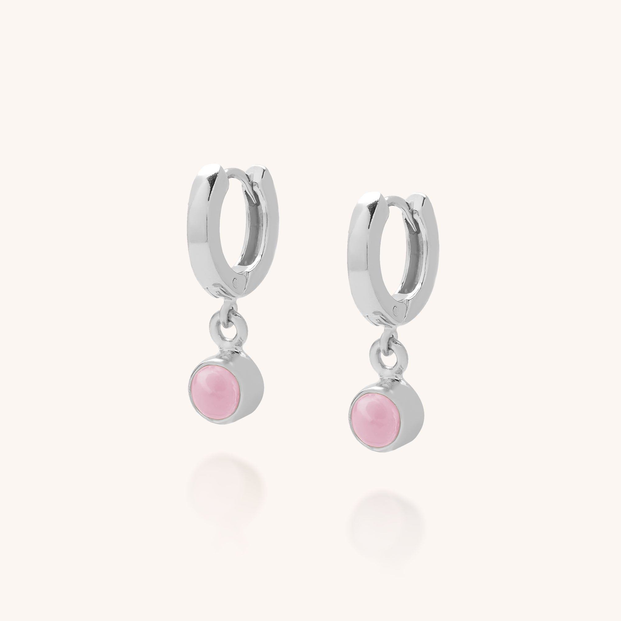 Gem Hoop Birthstone Earrings: Small sterling silver hoops with a dangling round natural gemstone in a silver bezel, shown against a plain light background.