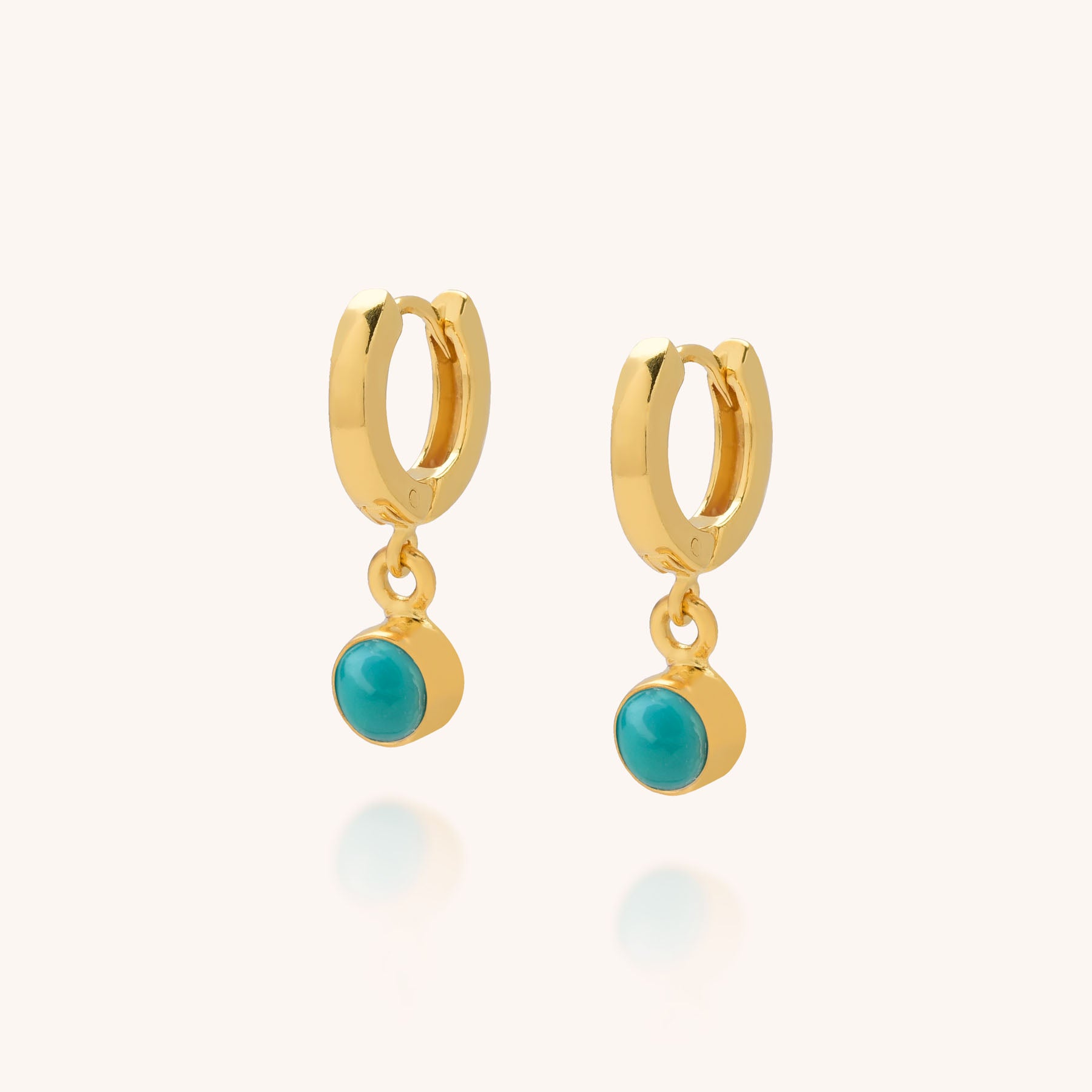 Gem Hoop Birthstone Earrings in gold, adorned with small natural turquoise gemstones that dangle elegantly, showcased on a light background.