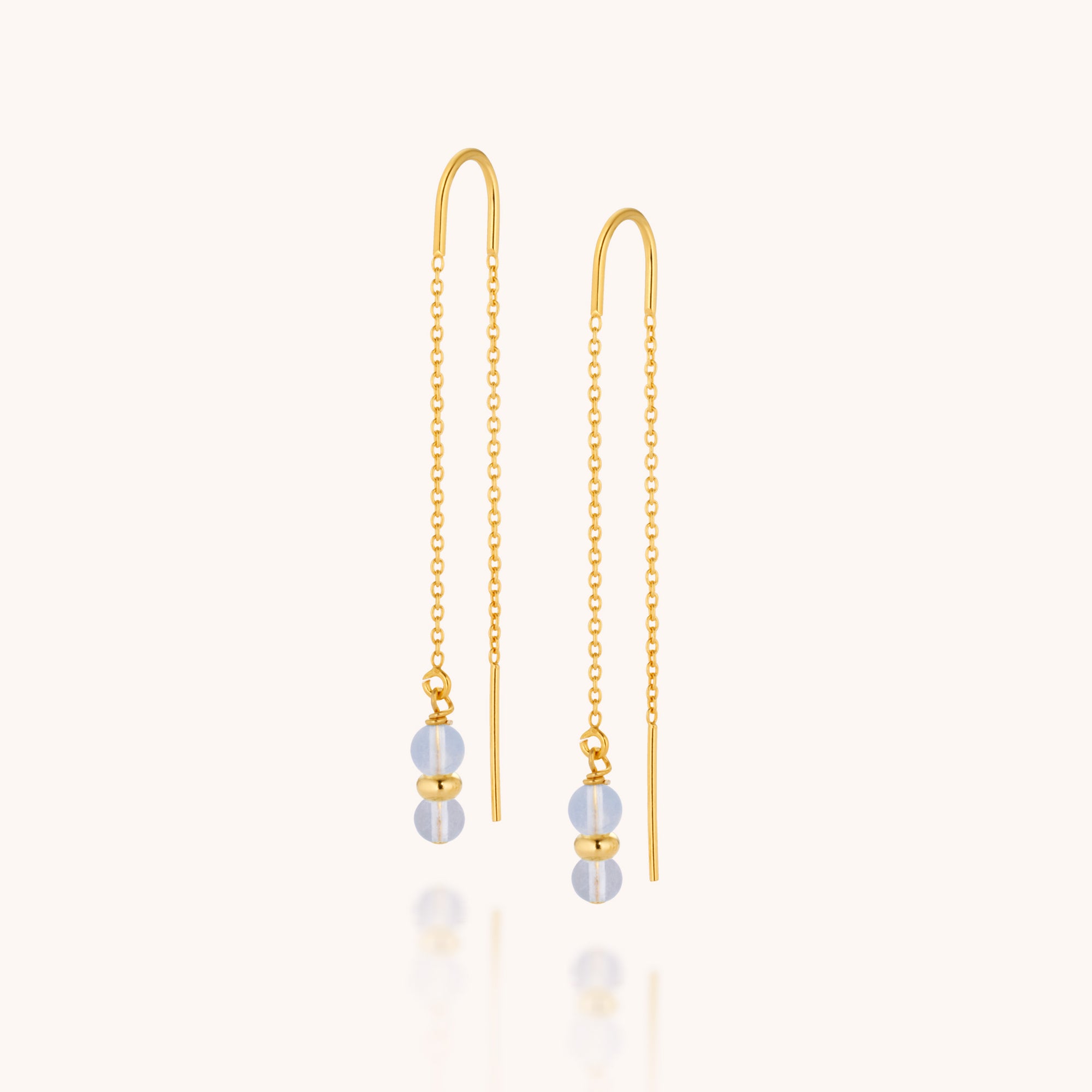 Fall Earrings Birthstone March: Gold chain threader earrings with two light blue Aquamarine gemstones and a small gold bead at each end, shown on a plain white background.