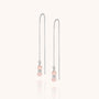 Fall Earrings Birthstone October: Sterling silver threader earrings with delicate chains, each featuring two small round Pink Opal beads and a silver spacer at the end. Displayed on a soft off-white background.