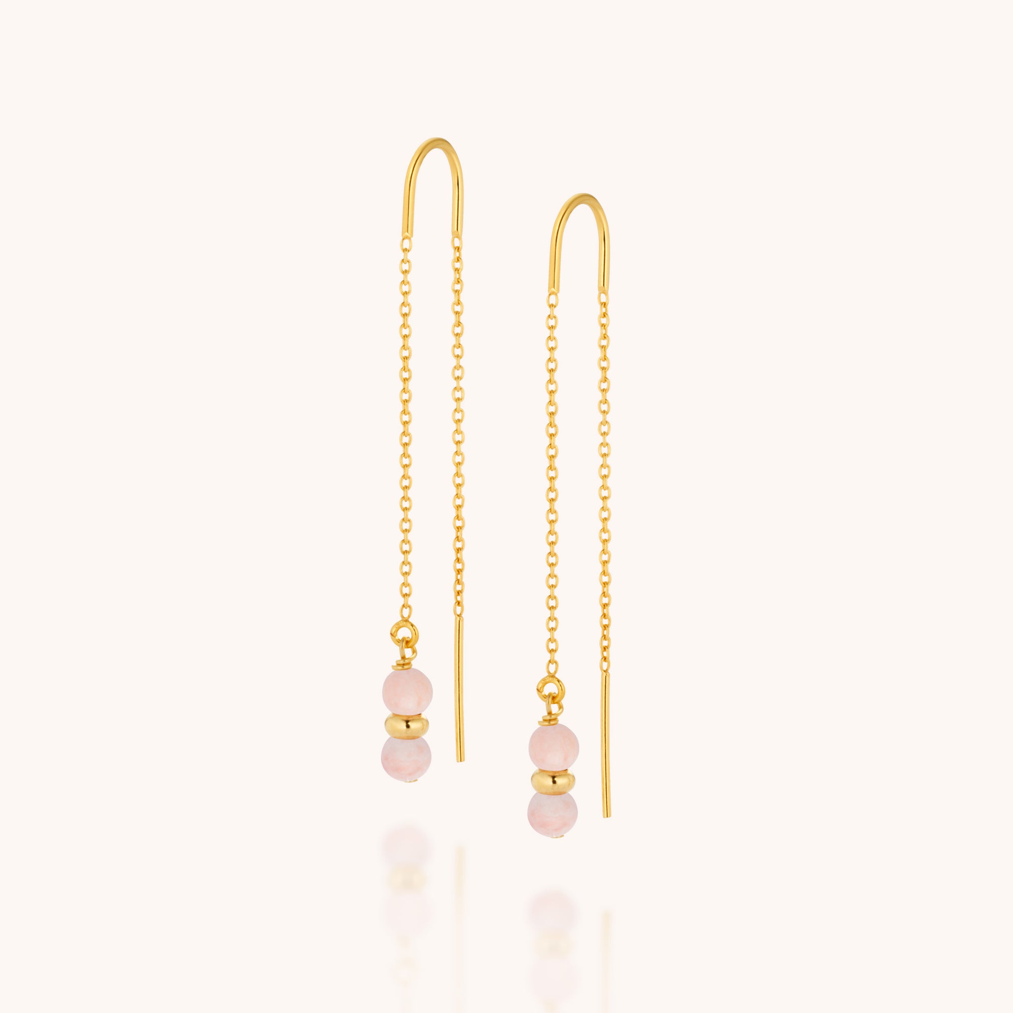 The Fall Earrings Birthstone October feature gold threader chains, each adorned with two small Pink Opal beads separated by a gold bead at the end. Shown on a simple, light background.