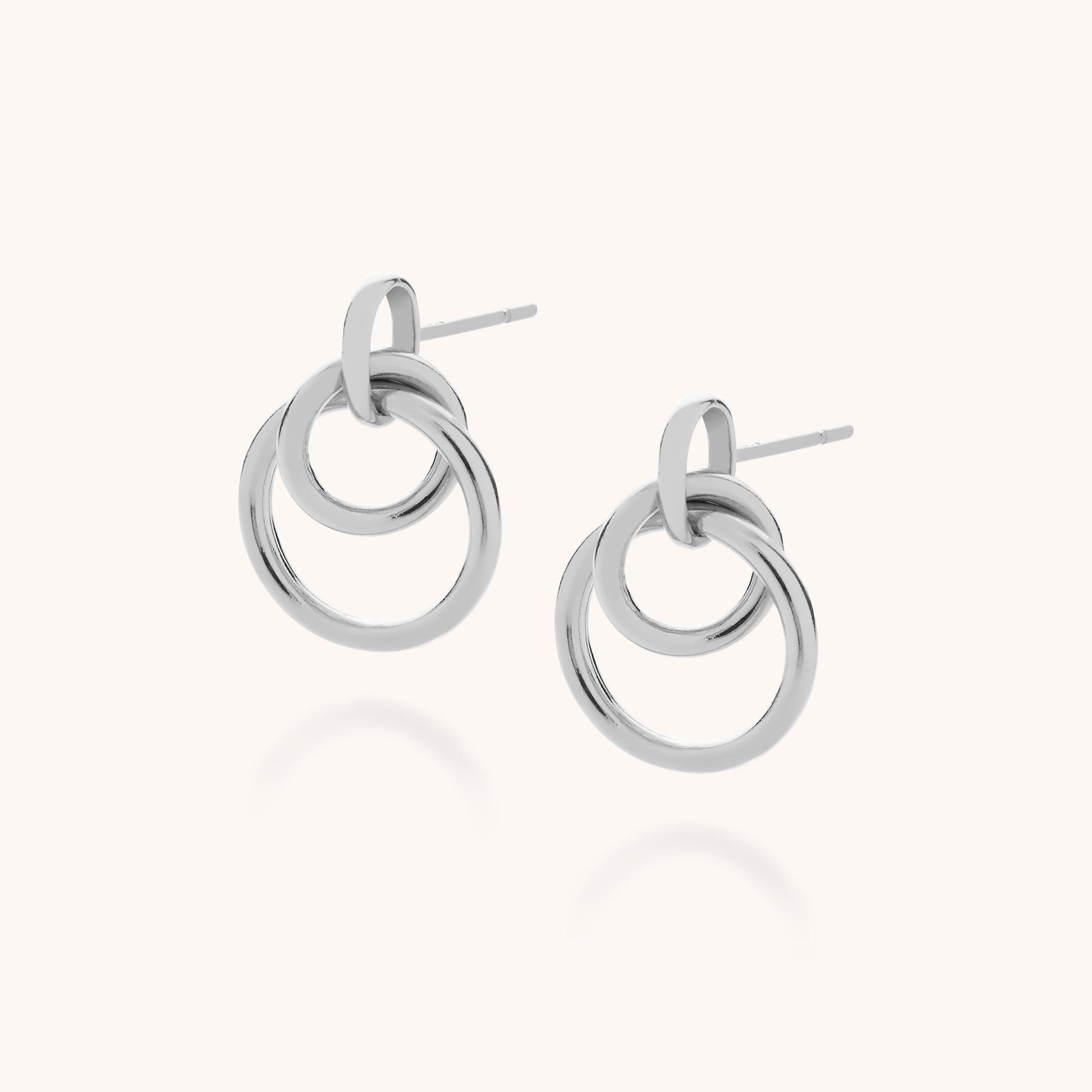 Double Hoop Ear Drop earrings feature two interlocking sterling silver hoops on each earring, shown against a plain light background.