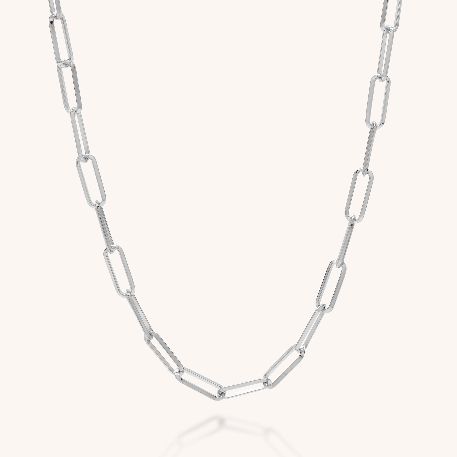The Triangular Paperclip Necklace, crafted from eco silver with evenly spaced, elongated triangular links, is displayed on a plain light background—a sustainable and stylish accessory.