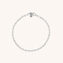 The Baby Paperclip Bracelet is a delicate eco-silver chain with elongated links and a round charm engraved with the letter N, shown on a plain light background.