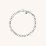 The Chunky Belcher Bracelet is crafted from eco-silver with round links, a lobster clasp, and a small oval tag engraved with N near the clasp. It’s displayed on a plain light background.