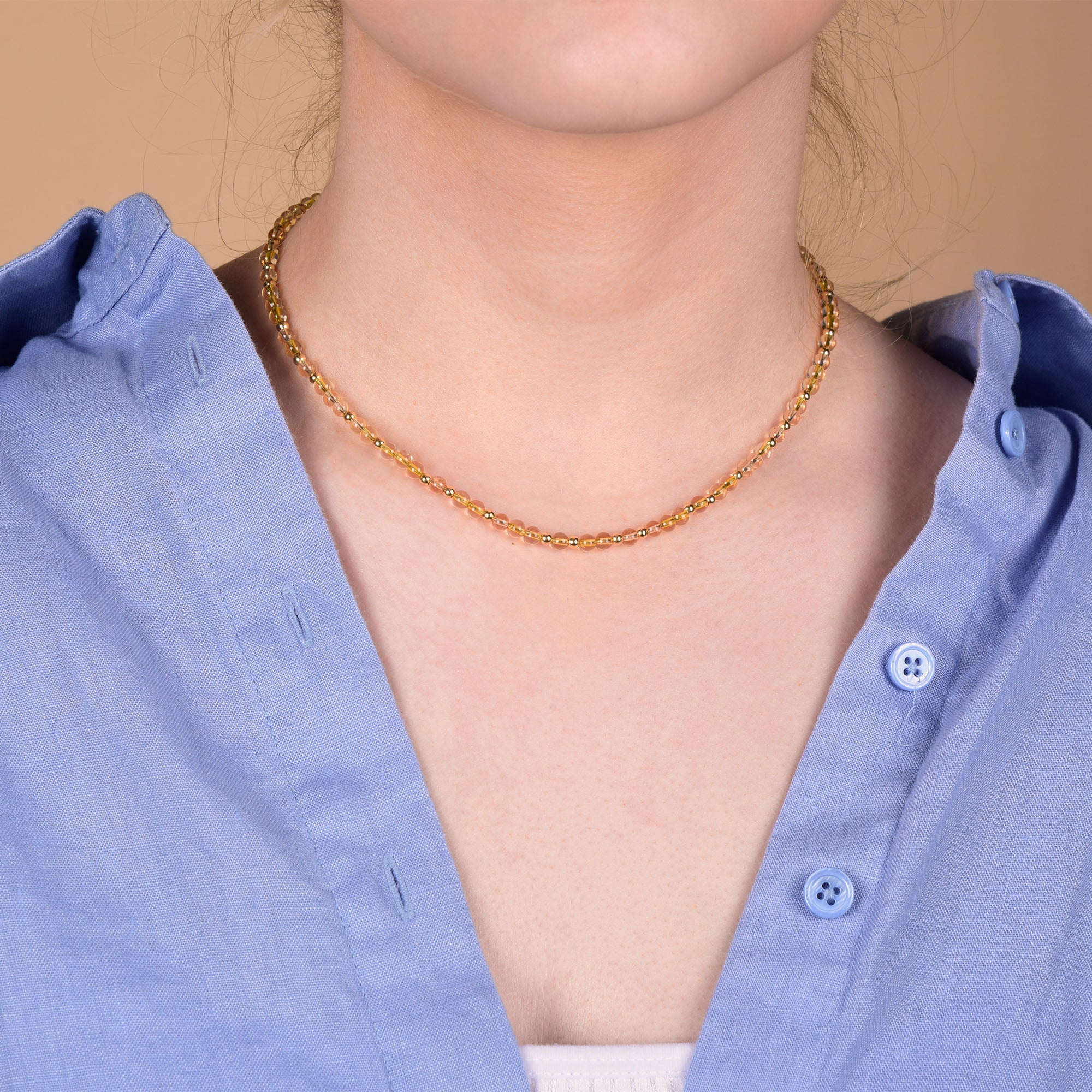 citrine necklace worn on a neck