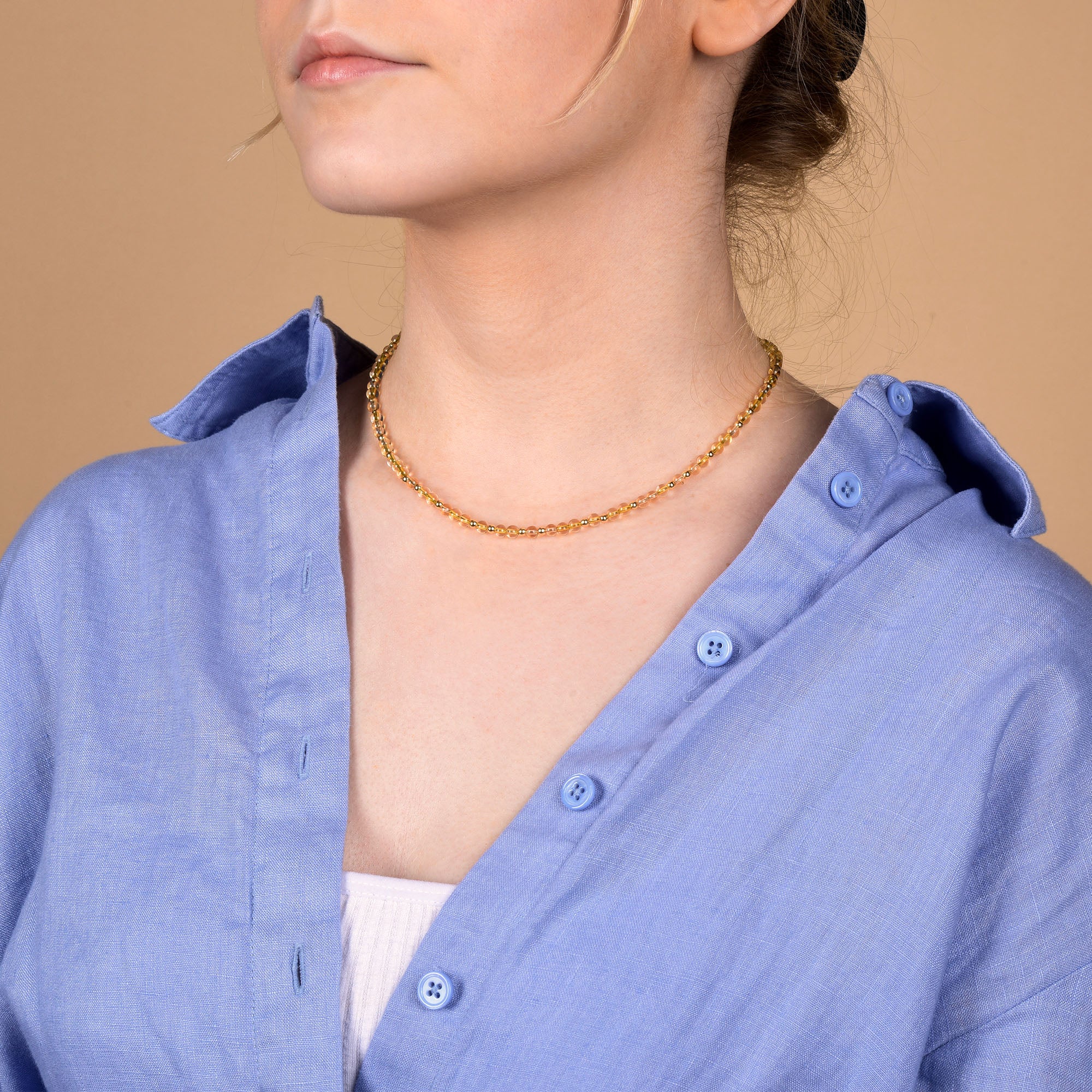 Girl in citrine necklace with slouchy shirt