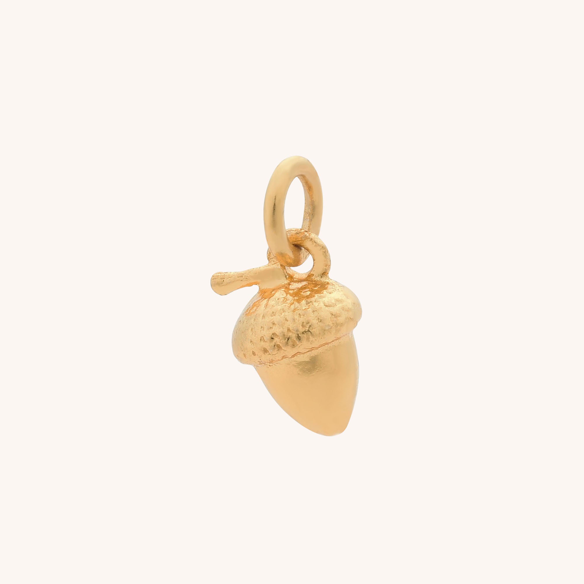 Gold acorn charm