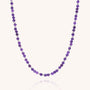 The Jewel Bead Birthstone Necklace - February features small, round, faceted Amethyst beads in a single strand, elegantly displayed against a plain white background.