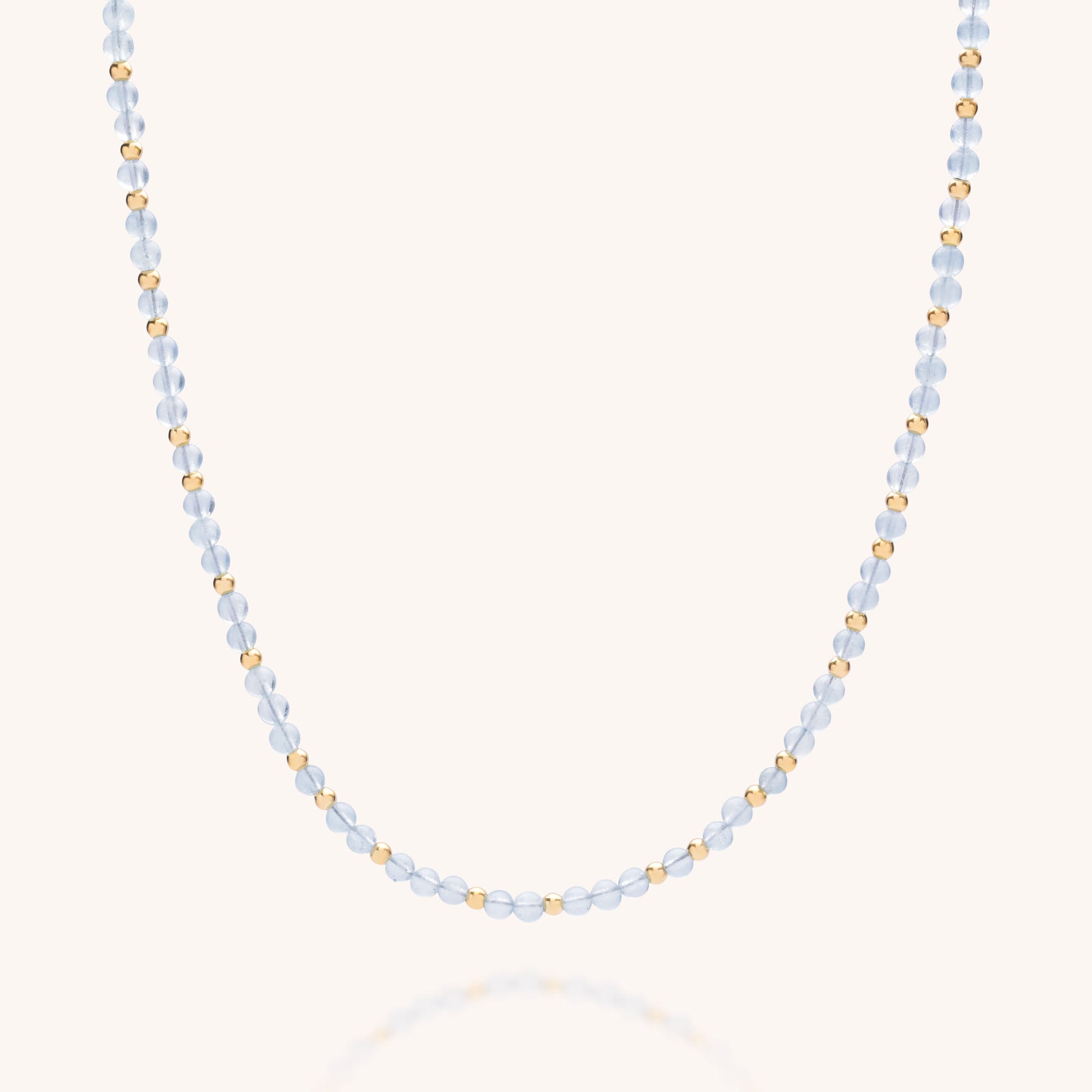 The Jewel Bead Birthstone Necklace - March showcases alternating pale blue and gold beads, making it an elegant, eco-friendly accessory ideal for those who love the March aquamarine birthstone.