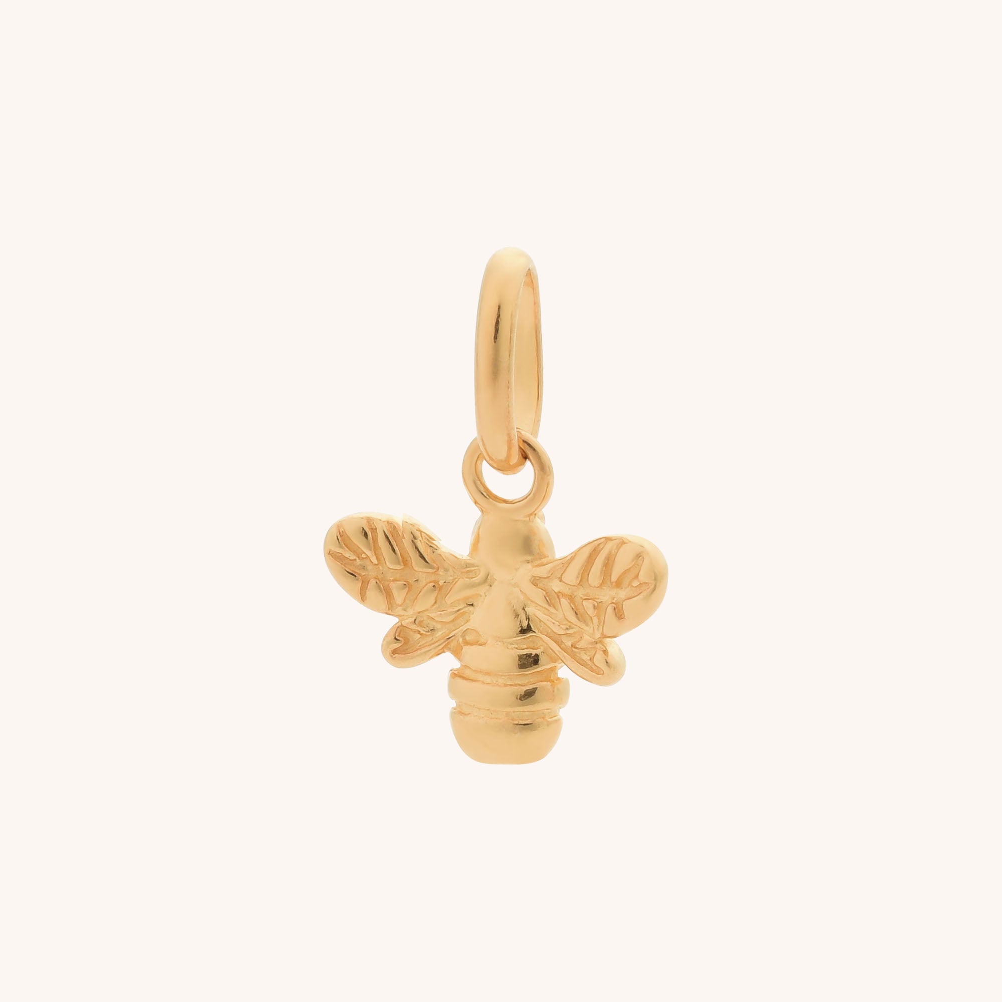 Bee Charm: Gold bee-shaped jewelry pendant with intricate wings and an attachment ring for necklaces or bracelets, shown on a plain light background.