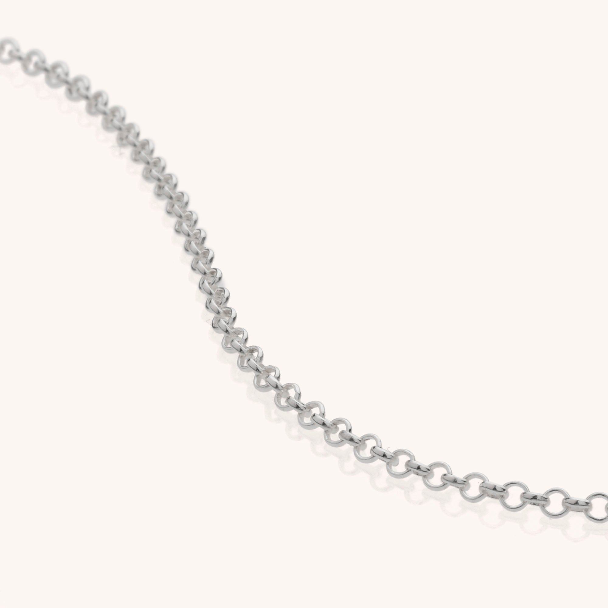 The Belcher Chain is a delicate necklace made from recycled sterling silver, featuring small round links in a gentle curve against a plain, light background.