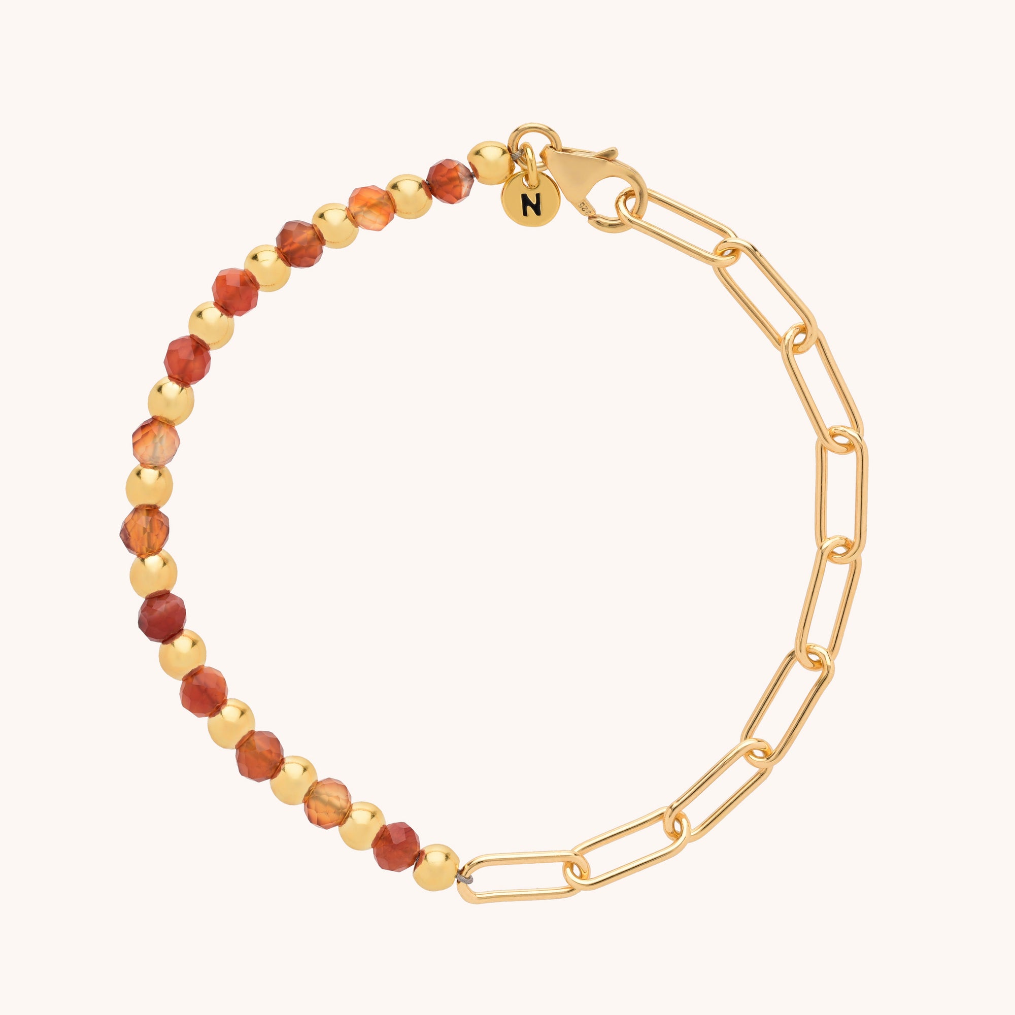 The Gem Shine Bracelet features one half with round gold beads and faceted gemstones, the other half with gold paperclip chain links in eco-silver sterling silver, finished with a clasp and engraved N charm.