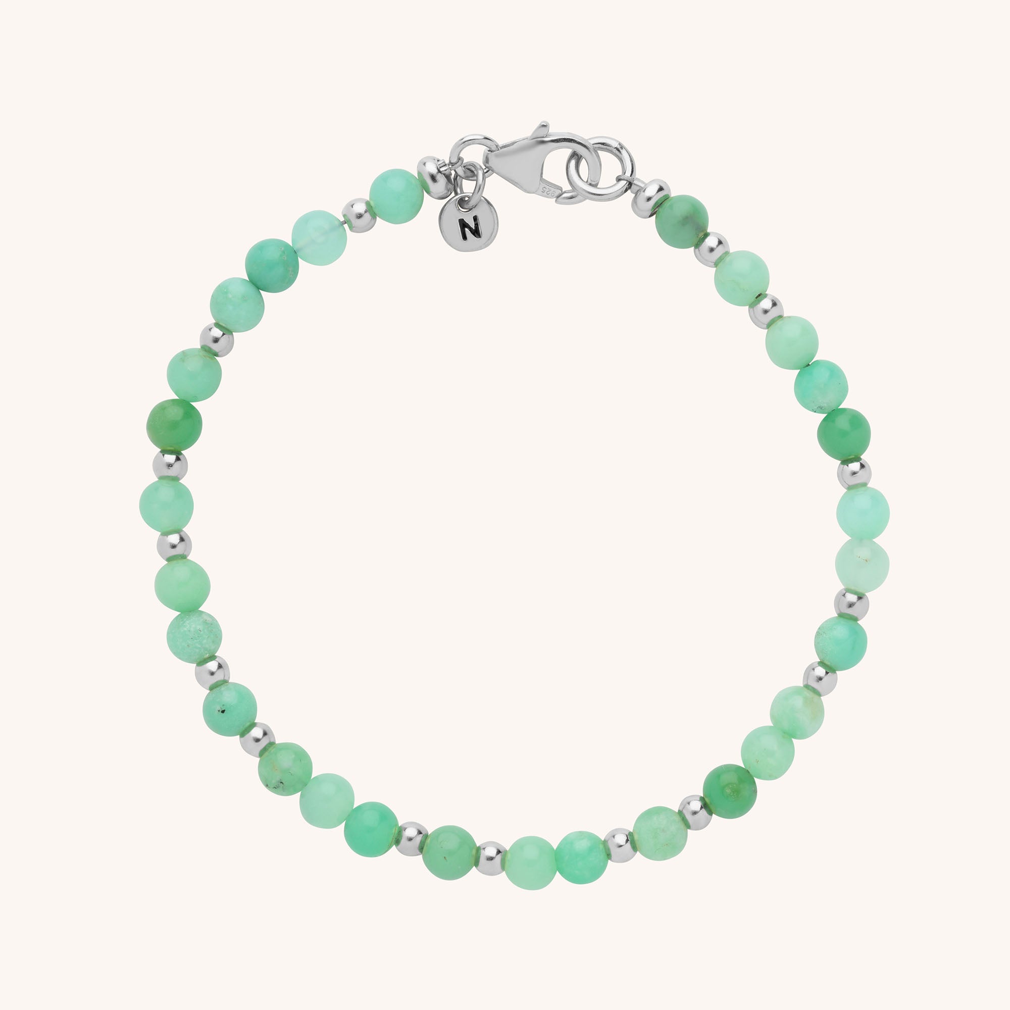 The Jewel Bead Birthstone Bracelet - May features alternating round green natural chrysoprase gemstones and small silver beads, finished with a silver clasp and an engraved N charm—perfect as a May birthstone gift.