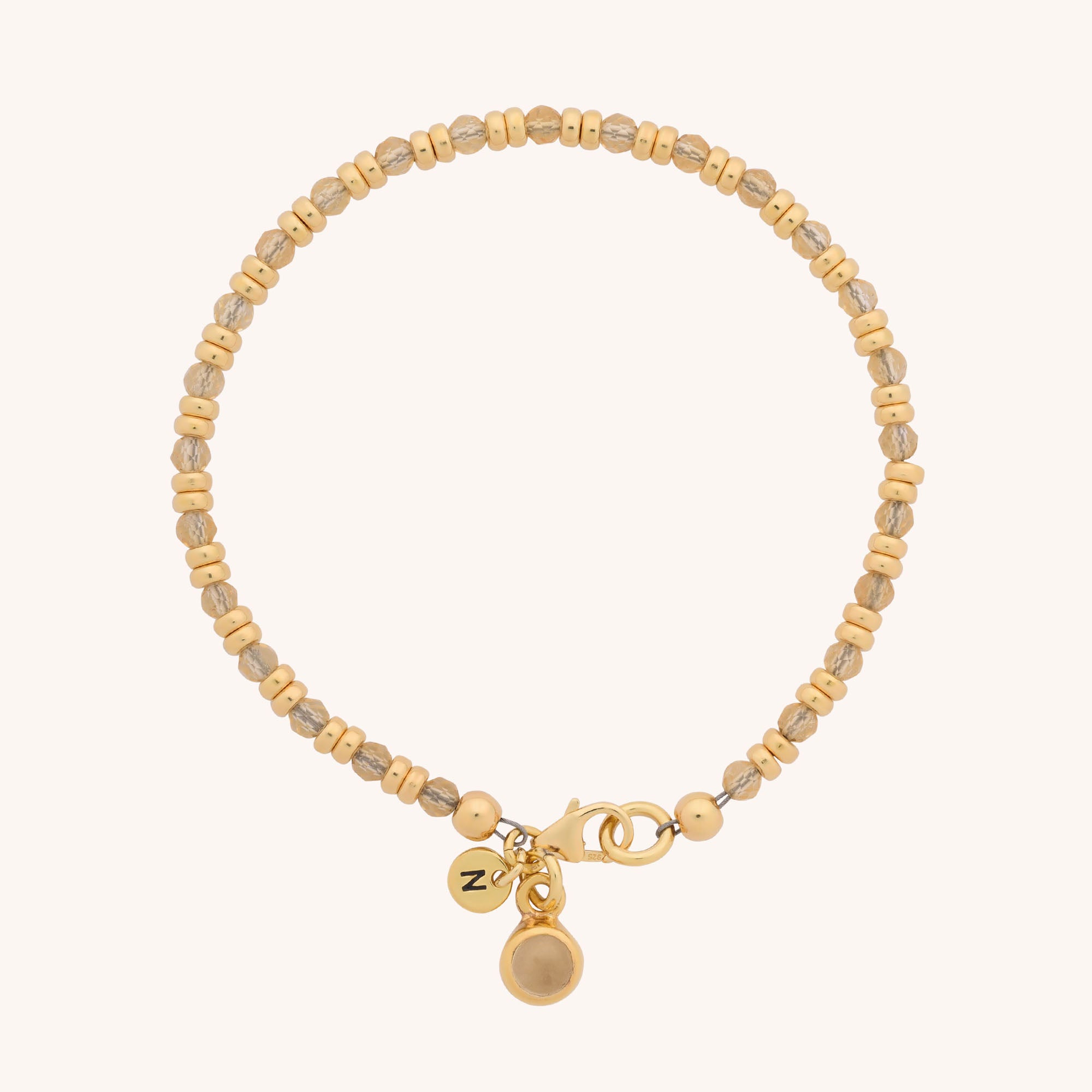 The Linear Birthstone Bracelet - November features a delicate gold beaded design with a small round charm and lobster clasp, perfect as a Citrine birthstone accessory, beautifully presented on a plain light background.