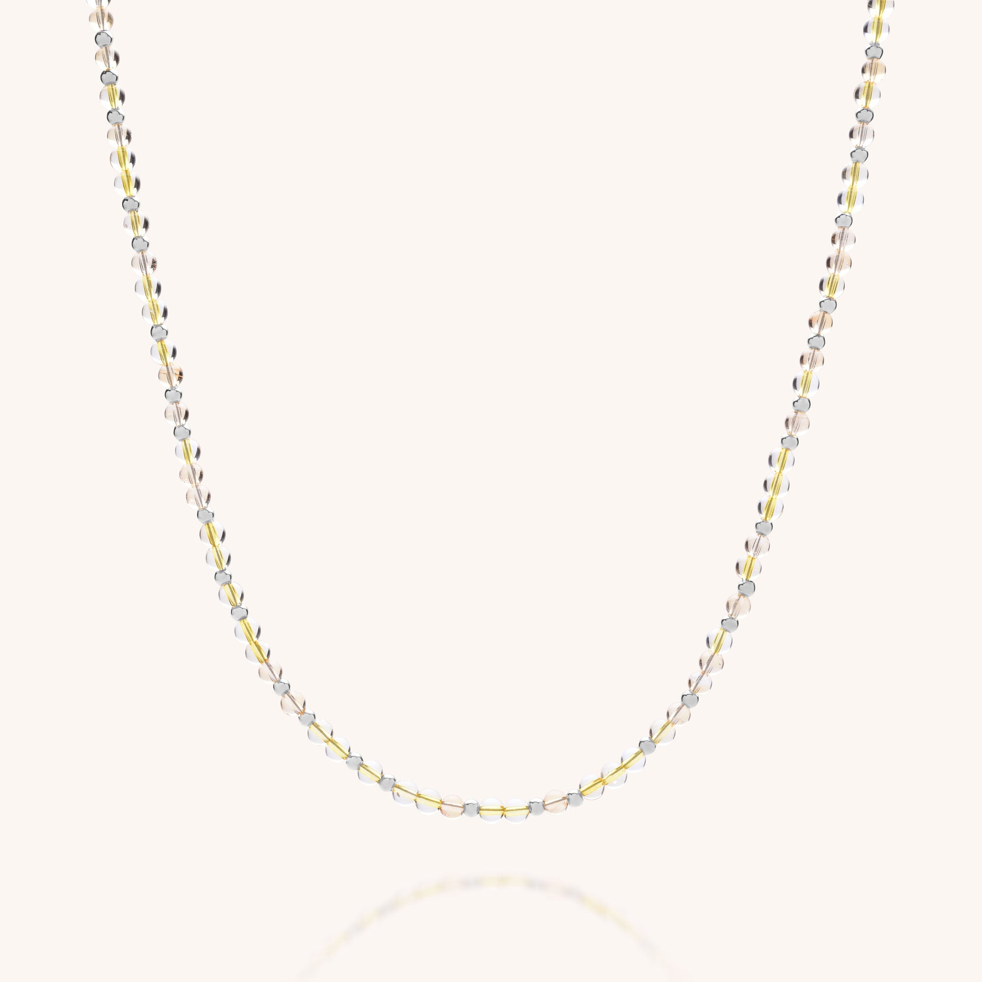 The Jewel Bead Birthstone Necklace - November features alternating small gold, sterling silver, and rose gold oval links, creating an eco-friendly piece displayed elegantly against a plain, light background.