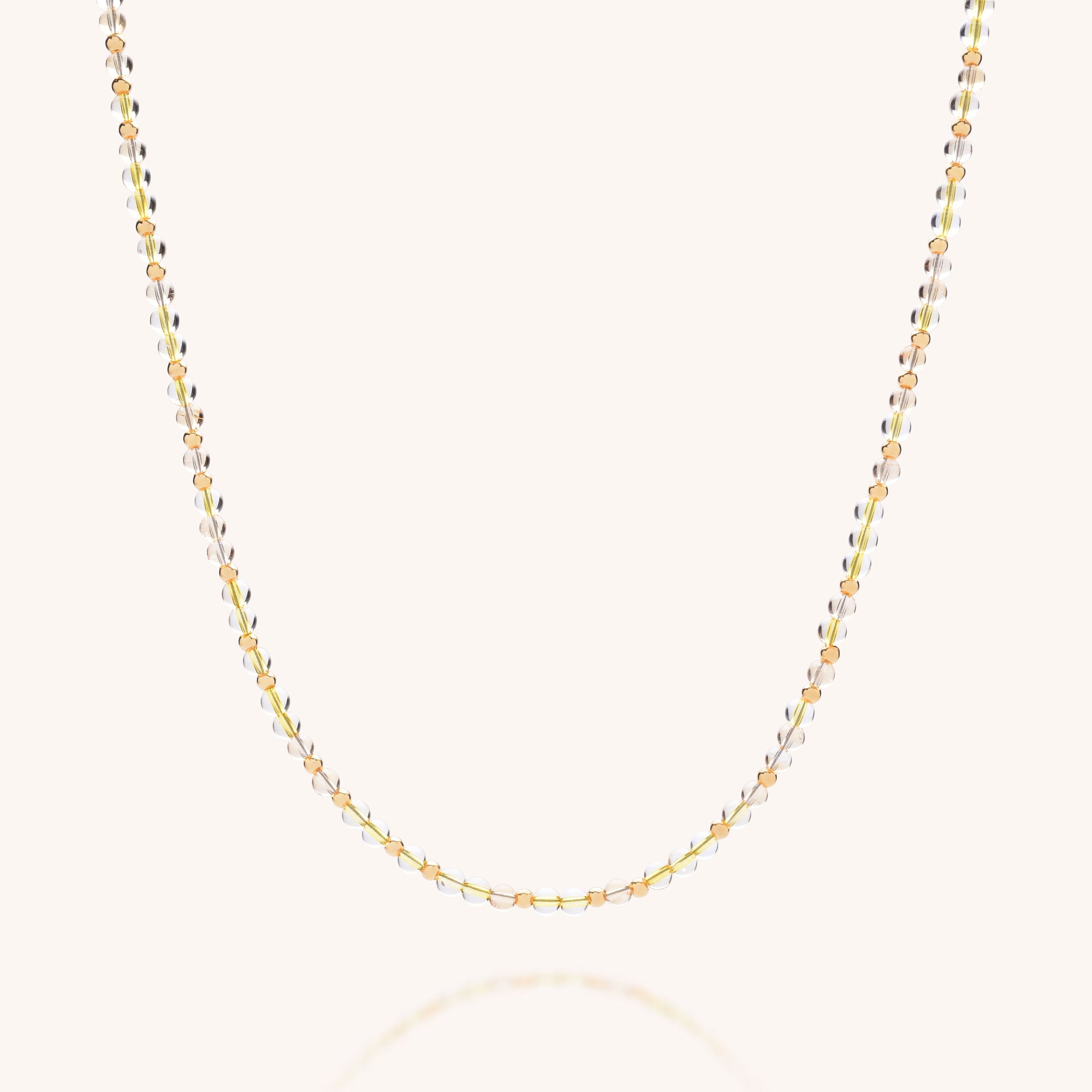 The Jewel Bead Birthstone Necklace - November features delicate citrine with alternating gold, rose gold, and sterling silver oval beads, elegantly displayed on a light background—an eco-friendly jewelry choice.