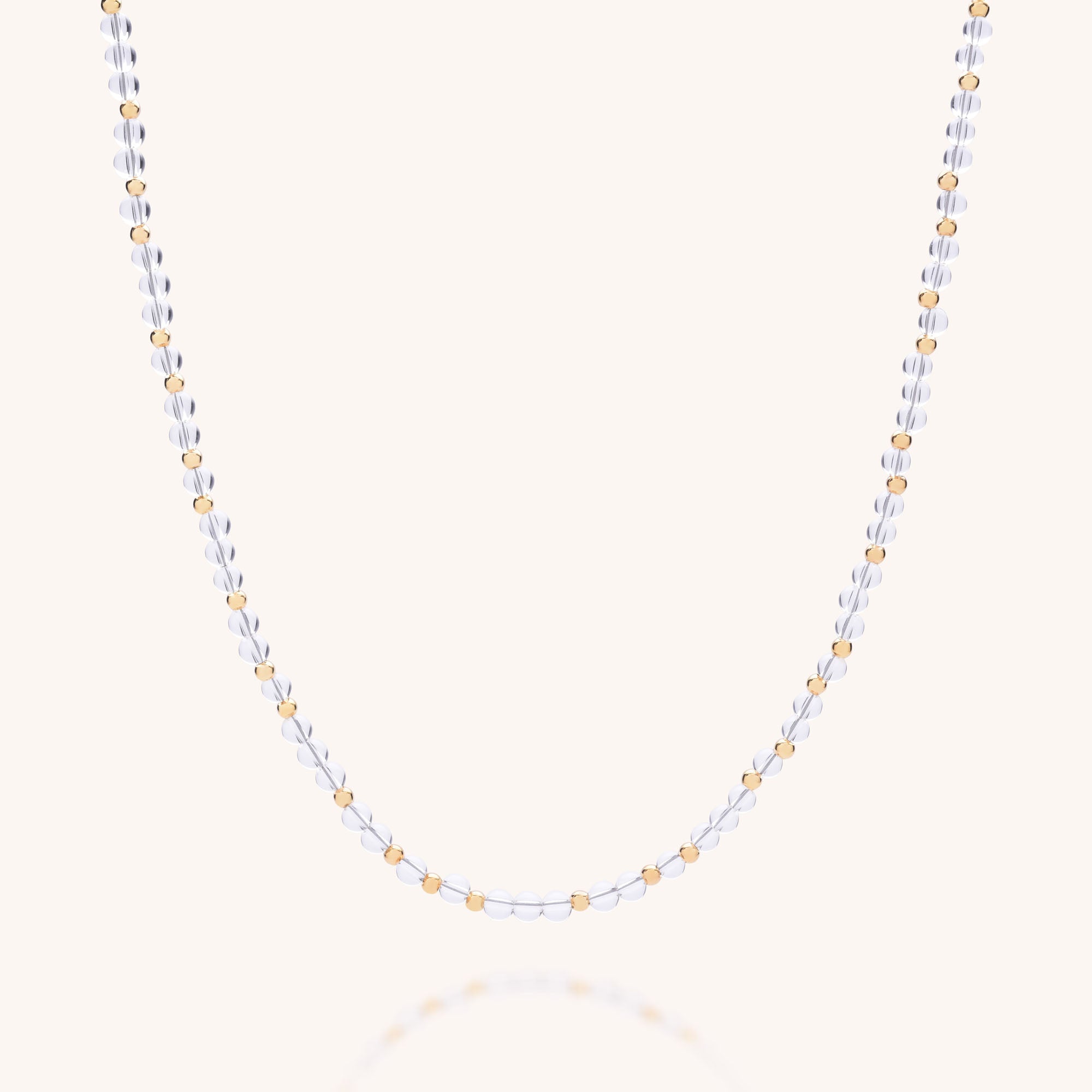 The Jewel Bead Birthstone Necklace - April is a handmade UK chain with alternating small silver and gold beads, shown on a simple light background.