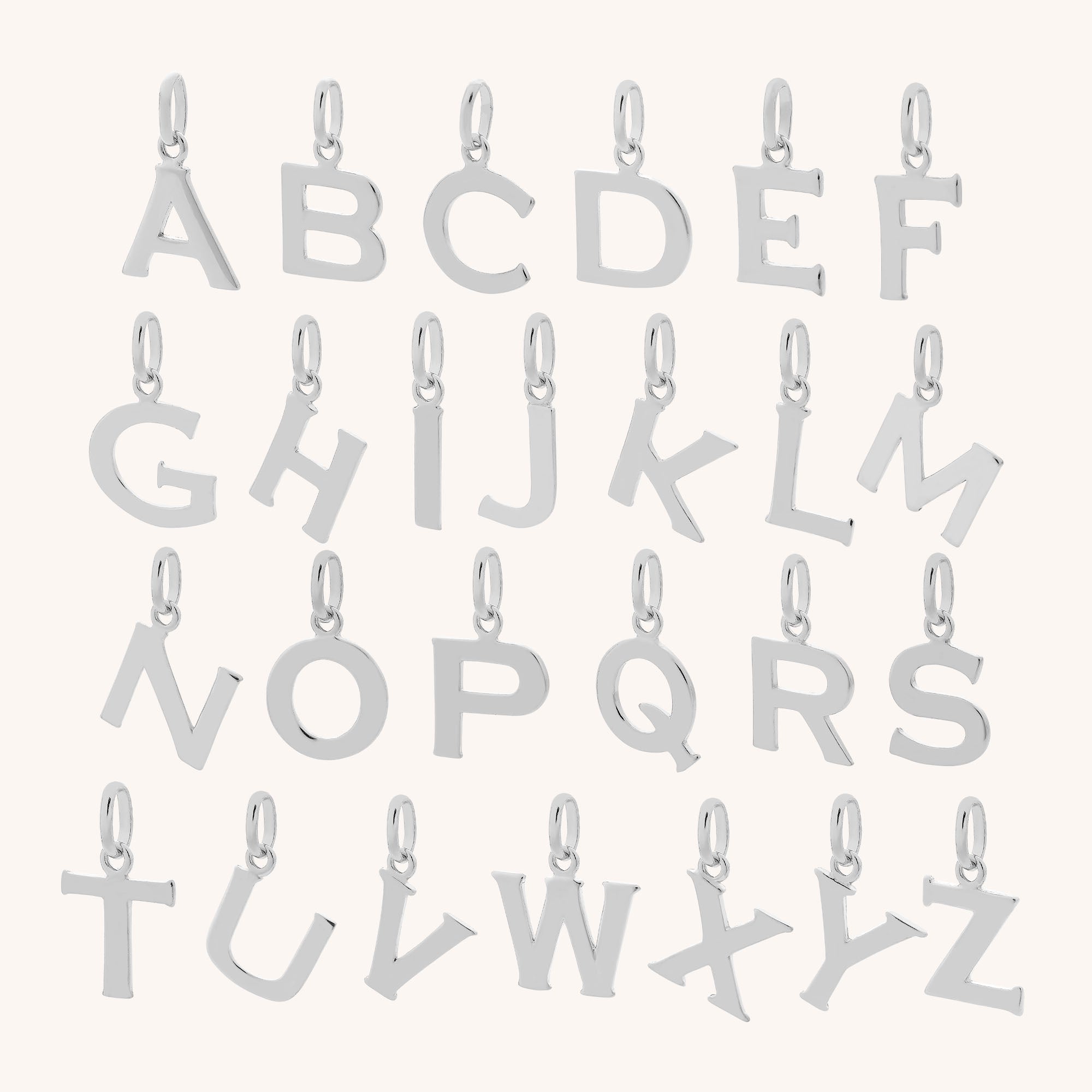 A set of eco sterling silver Satellite Chain letter charms from A to Z, each with a small loop for attaching to a bracelet or necklace, arranged in four rows on a light background.