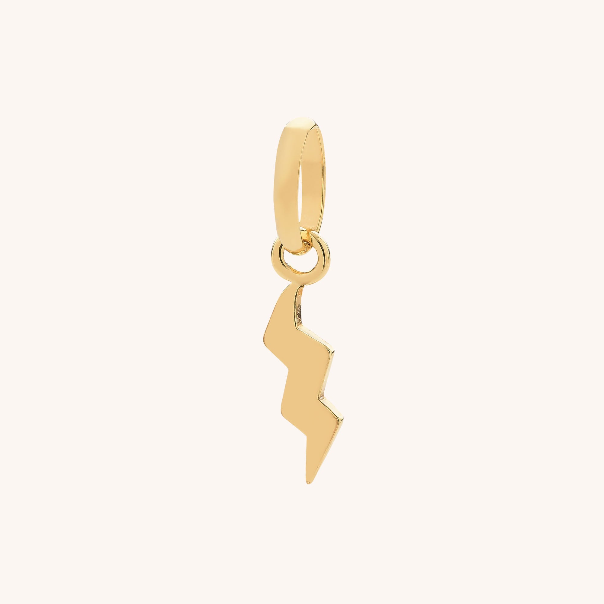 The Lightning Charm is a gold zigzag lightning bolt attached to a small round hoop, displayed on a plain background—a bold accessory for sterling silver jewelry lovers.