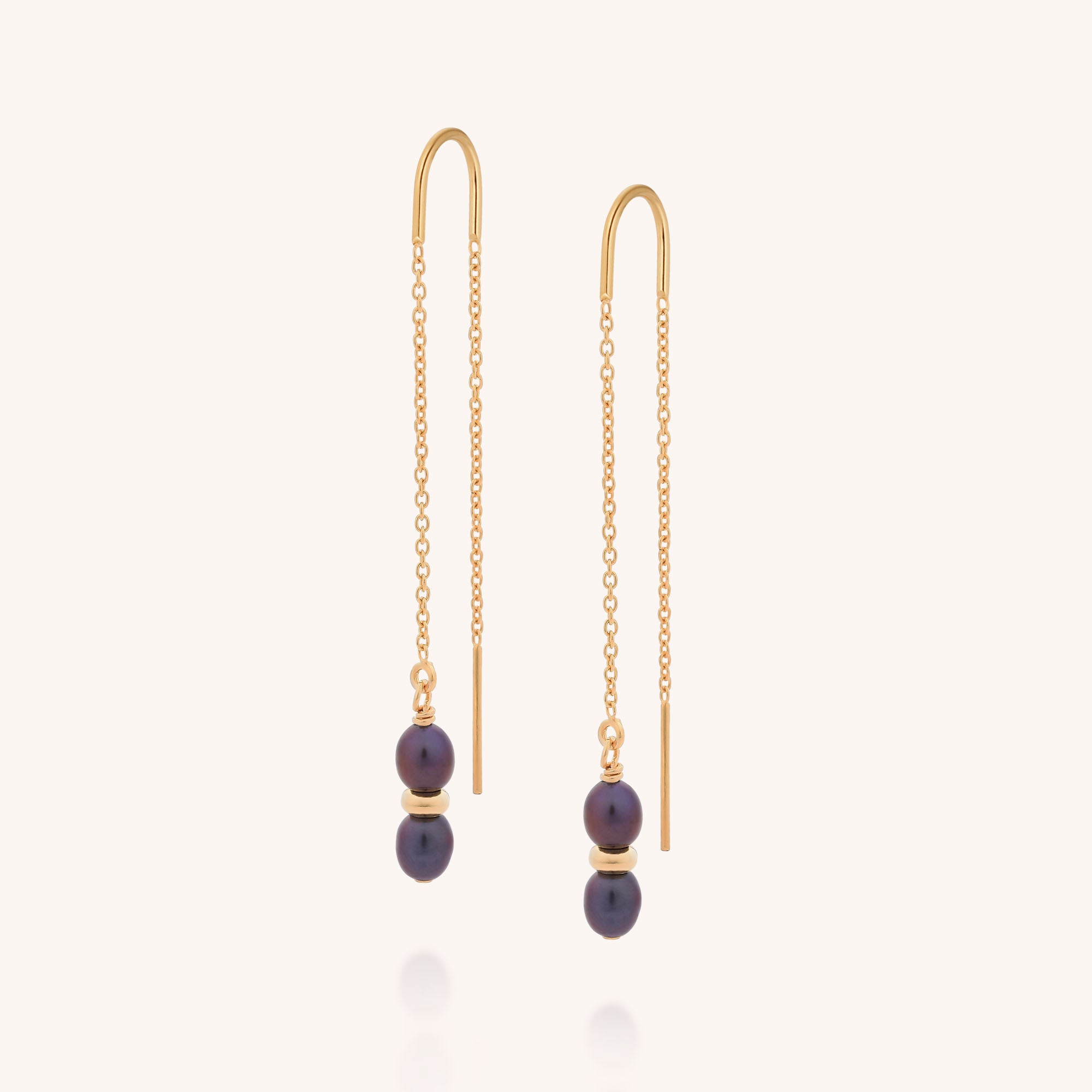 The Ellen Pearl Fall Earrings are gold plated chain threader earrings featuring two small dark purple beads stacked at the end of each, shown on a plain light background.