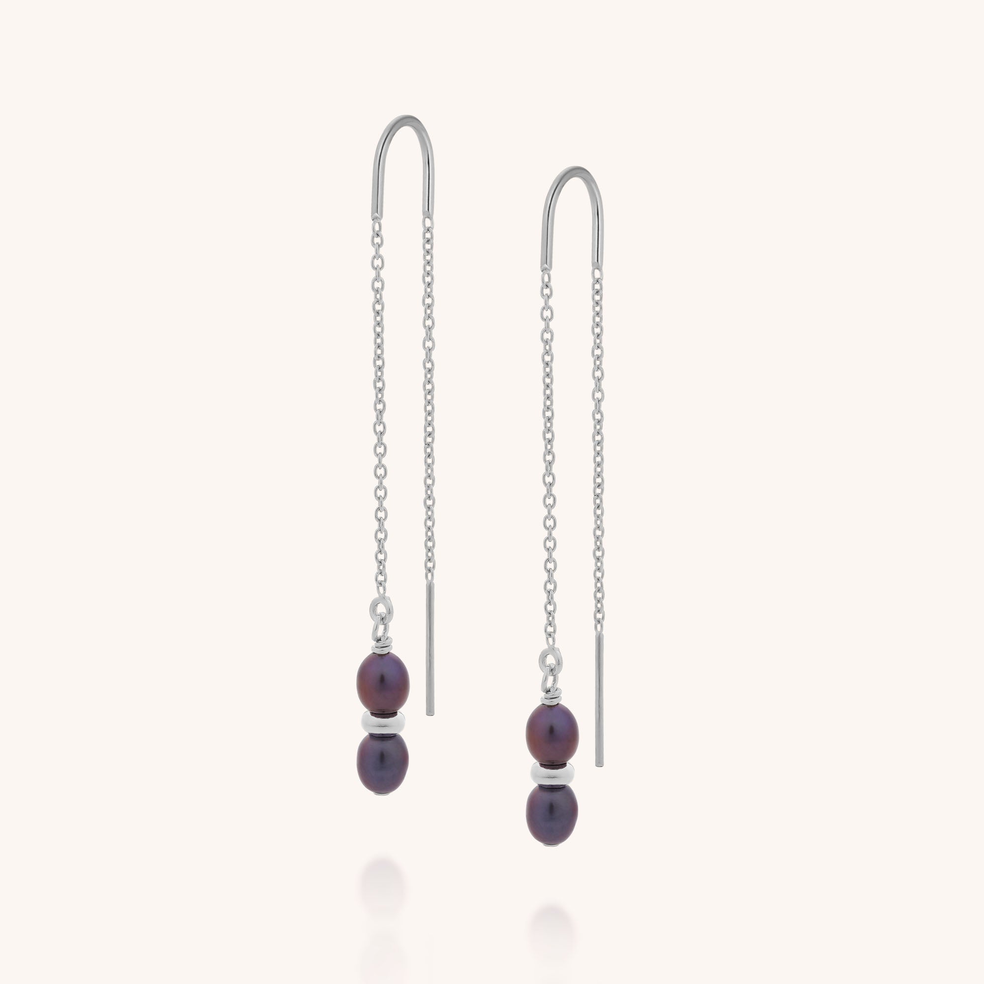 The Ellen Pearl Fall Earrings are sterling silver threaders featuring two small round dark purple beads on each, separated by a thin silver spacer and suspended from delicate chains.