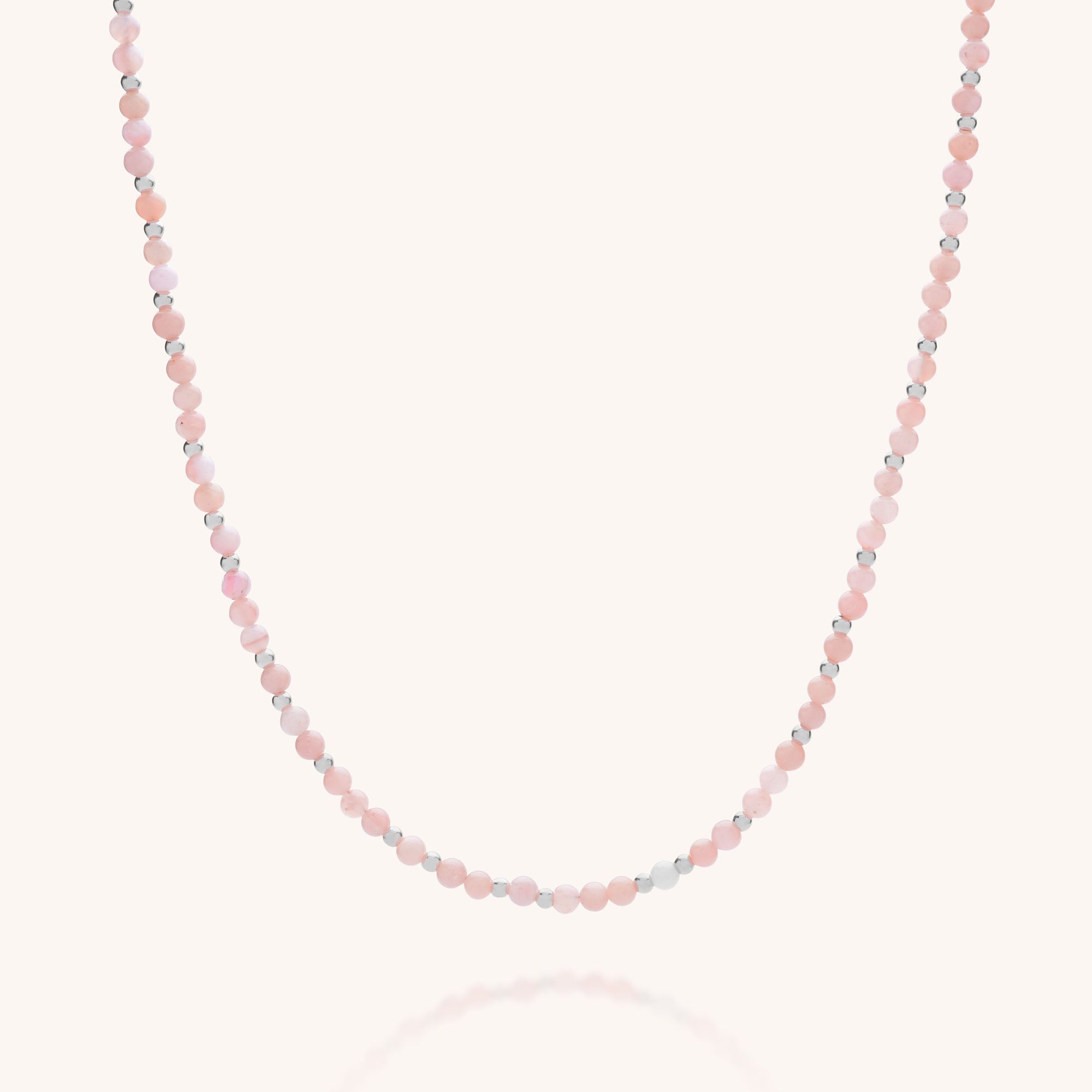 The Jewel Bead Birthstone Necklace - October features delicate round pink opal beads and tiny silver accents in a simple, elegant single strand—a beautiful, eco-friendly jewelry choice.