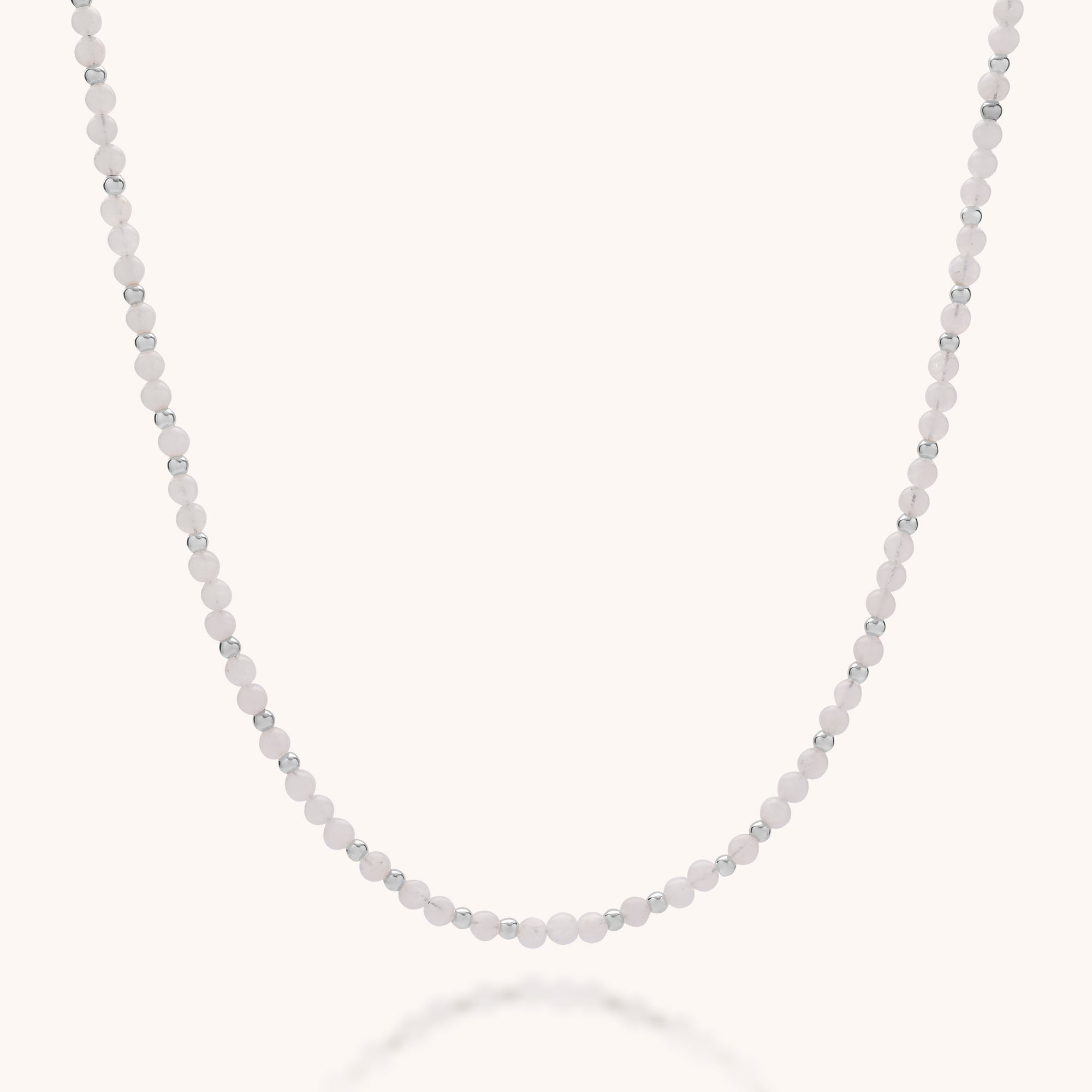The Jewel Bead Birthstone Necklace - June features alternating small white and eco-friendly sterling silver beads, elegantly displayed in a gentle curve on a plain light background.