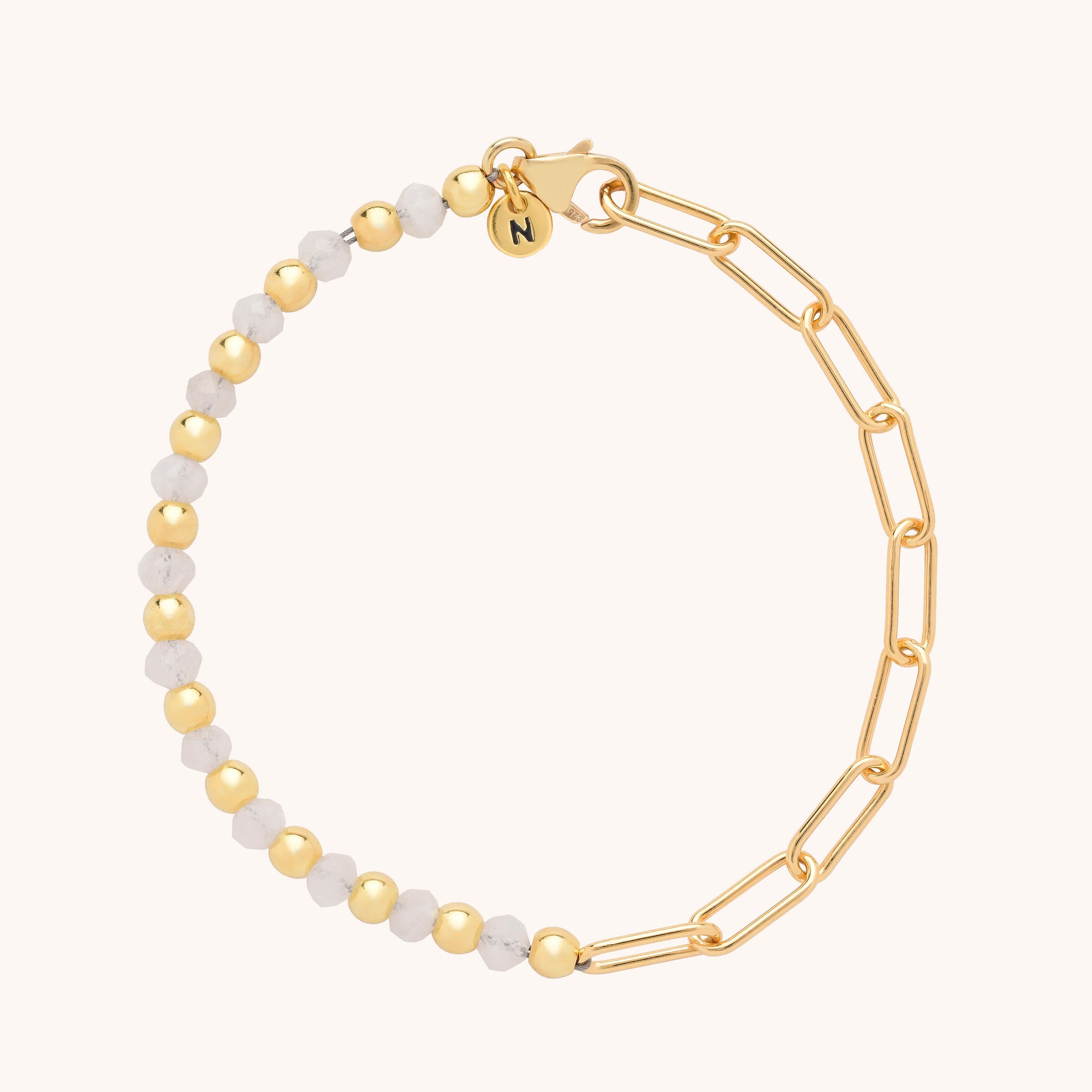 The Gem Shine Bracelet showcases half gold and half marbled white round beads, natural gemstones, chunky gold chain links, and a gold clasp with a small round charm.