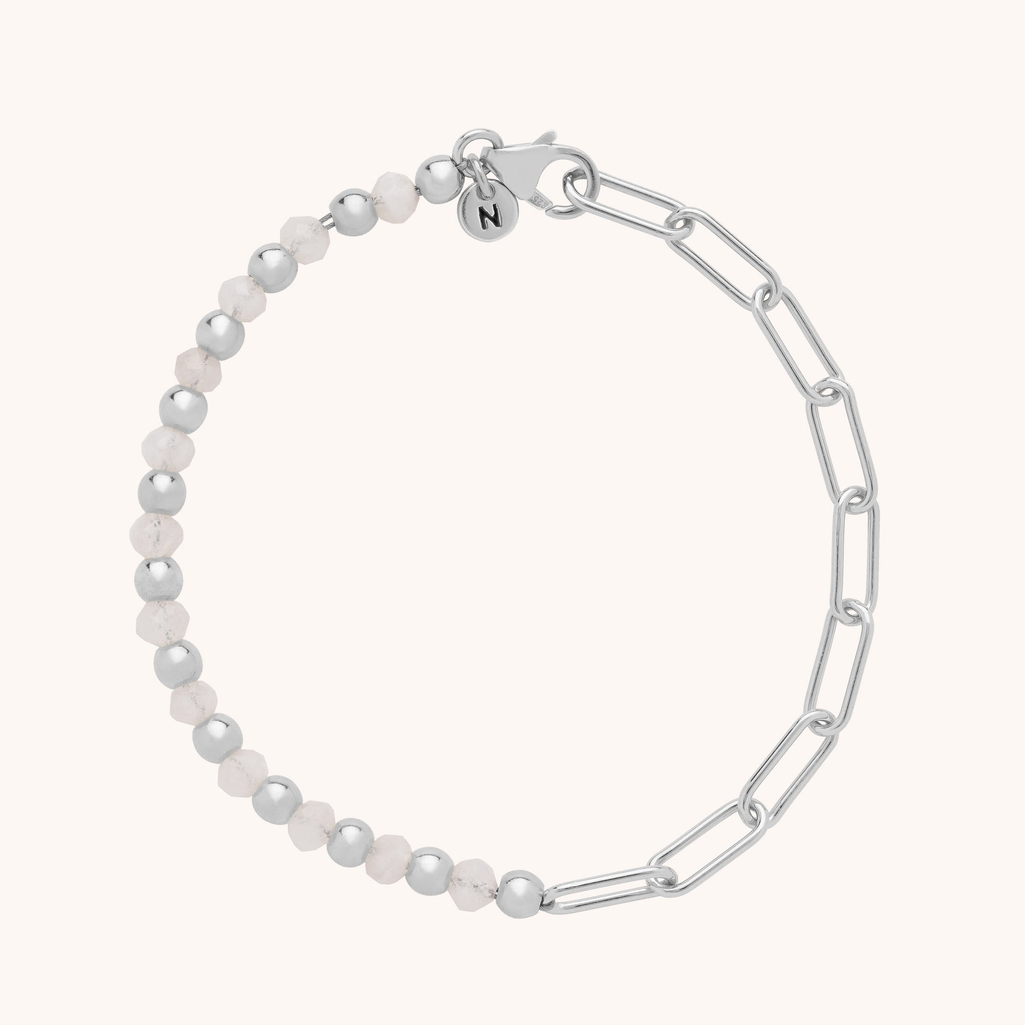 The Gem Shine Bracelet combines eco-silver beads and light pink natural gemstones, joined by a silver chain with elongated links and finished with a small circular charm near the clasp.