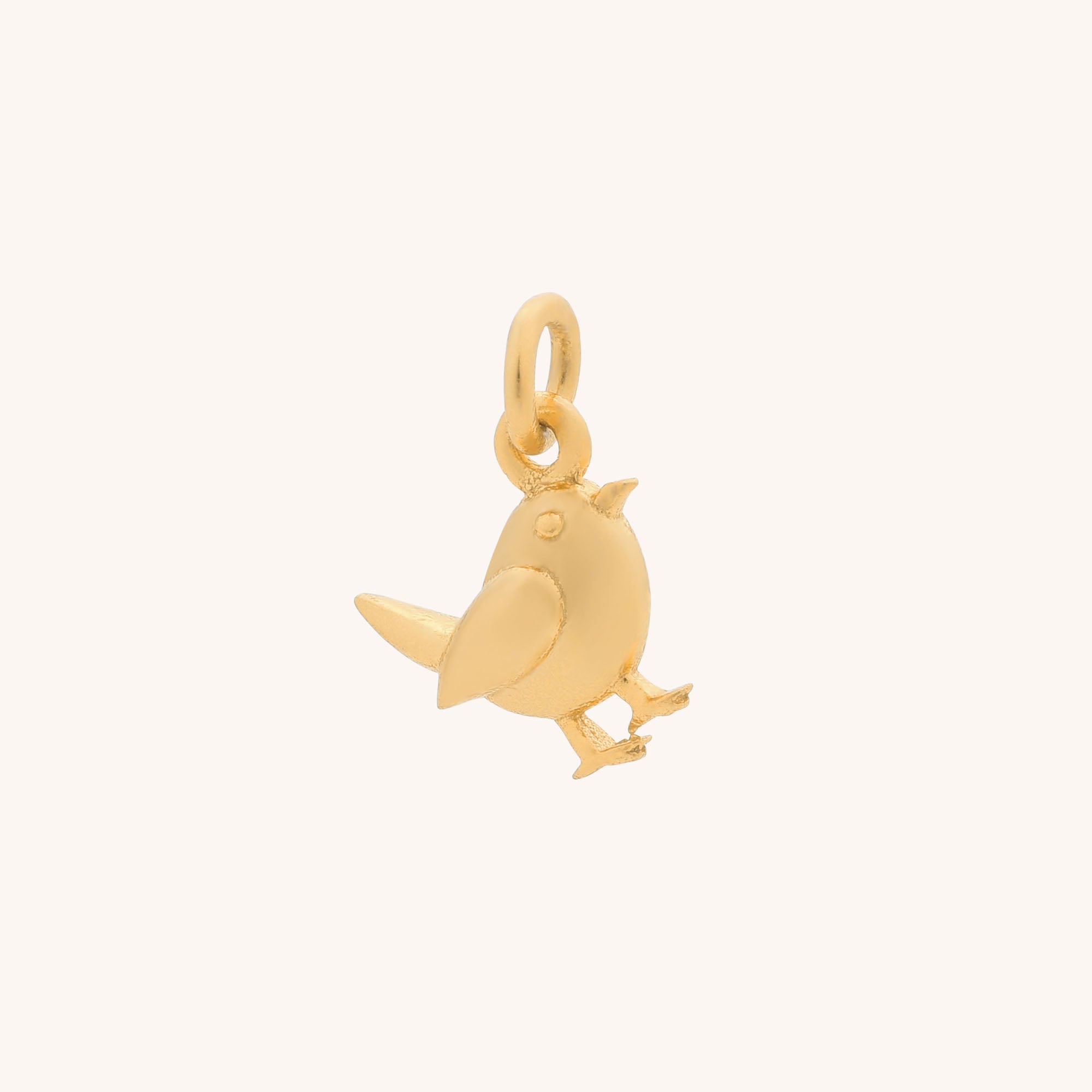 The Robin Charm is a small, gold-colored pendant with a top loop for easy attachment to necklaces or bracelets, displayed on a plain light background—a delightful addition to your sterling silver jewellery collection.