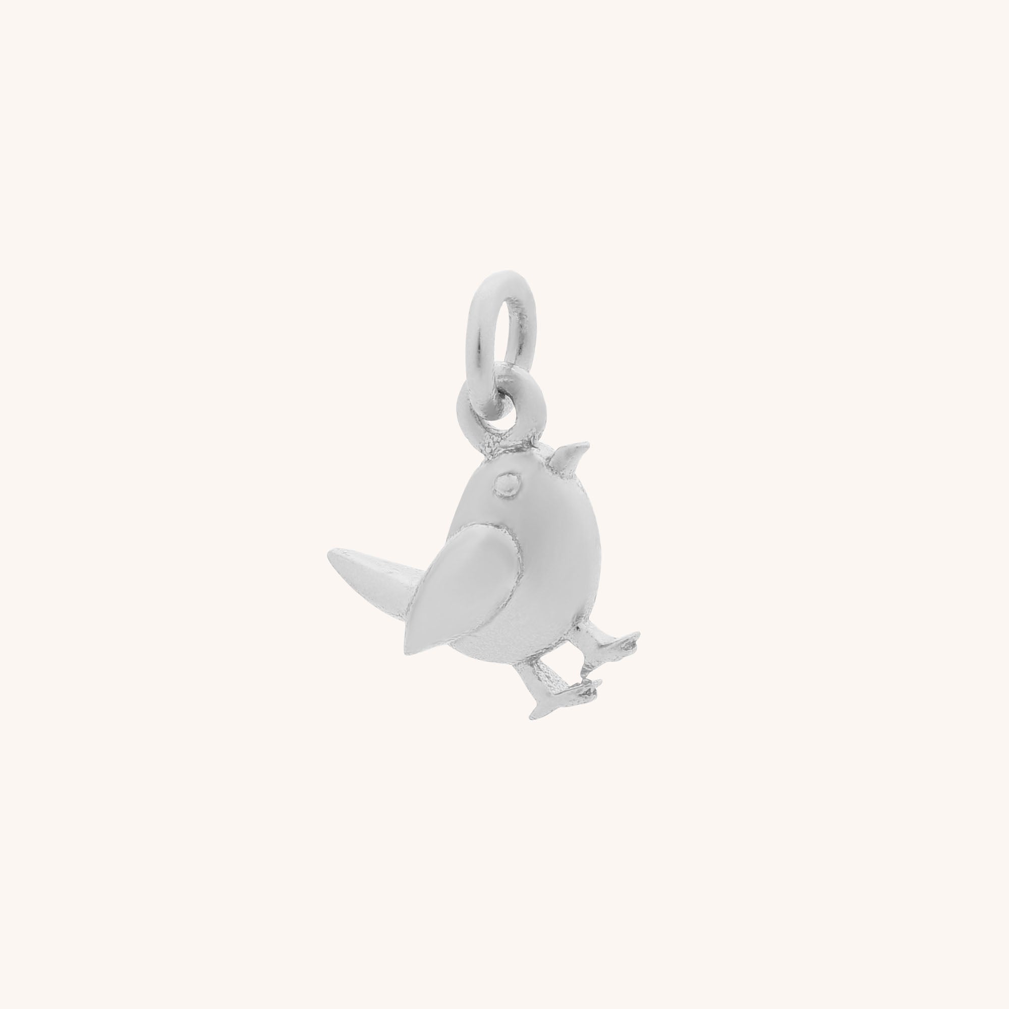 The Robin Charm is a small sterling silver piece with a top loop for attaching to necklaces or bracelets, shown on a plain light background.