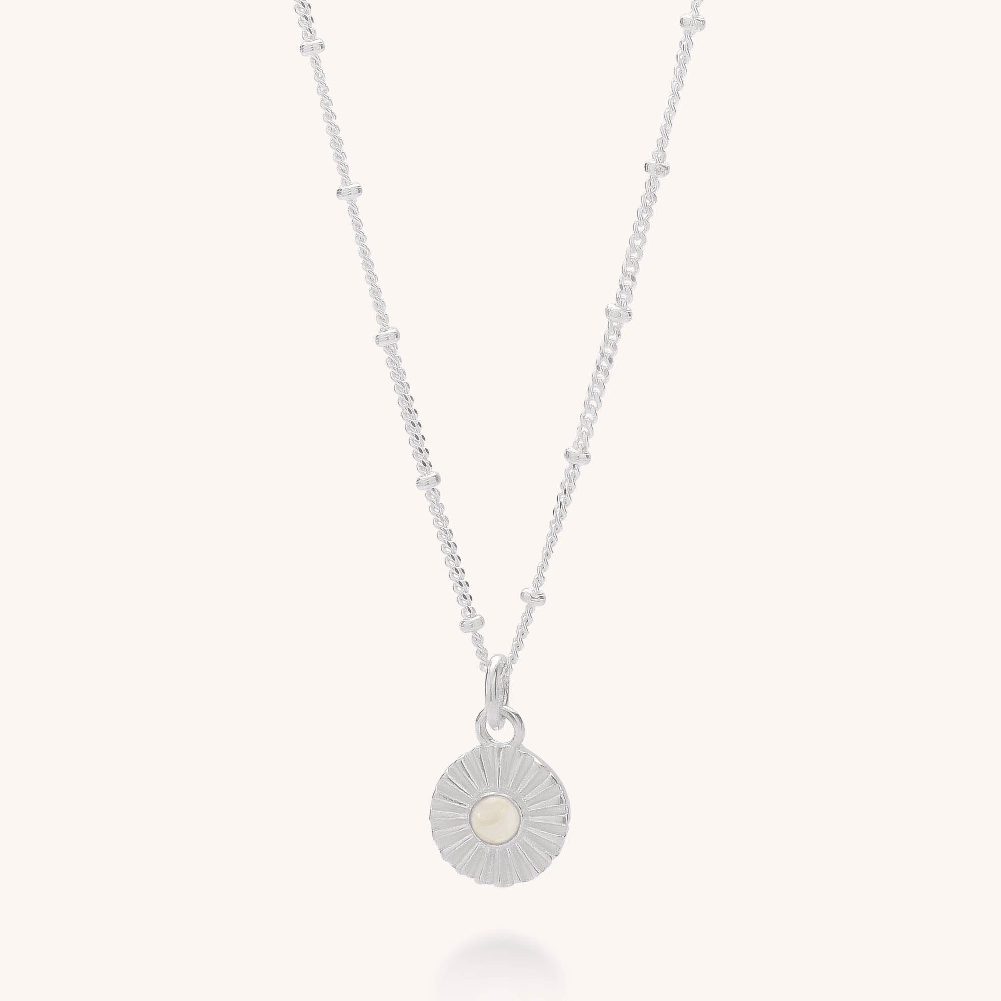 The Radiance Birthstone Necklace - October features a sterling silver chain with small decorative beads and a round sunburst pendant centered by an Ethiopian opal—an elegant, unique gift for October birthdays.