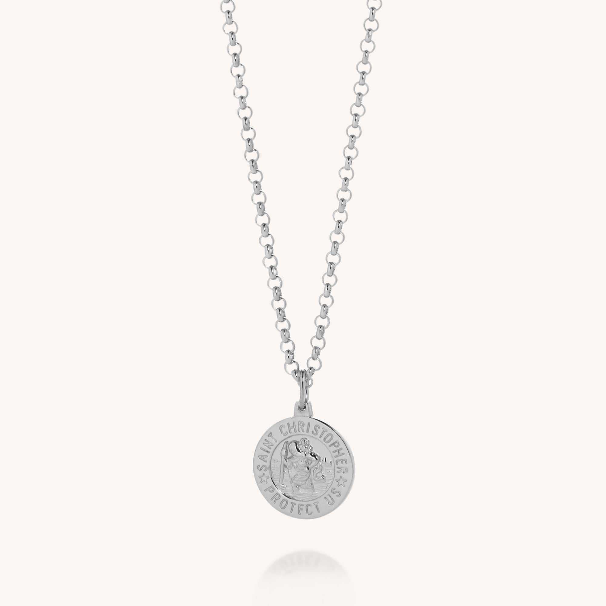 The Saint Christopher Necklace is crafted from eco-friendly sterling silver with a round pendant engraved SAINT CHRISTOPHER PROTECT US and features a chain of evenly spaced circular links.