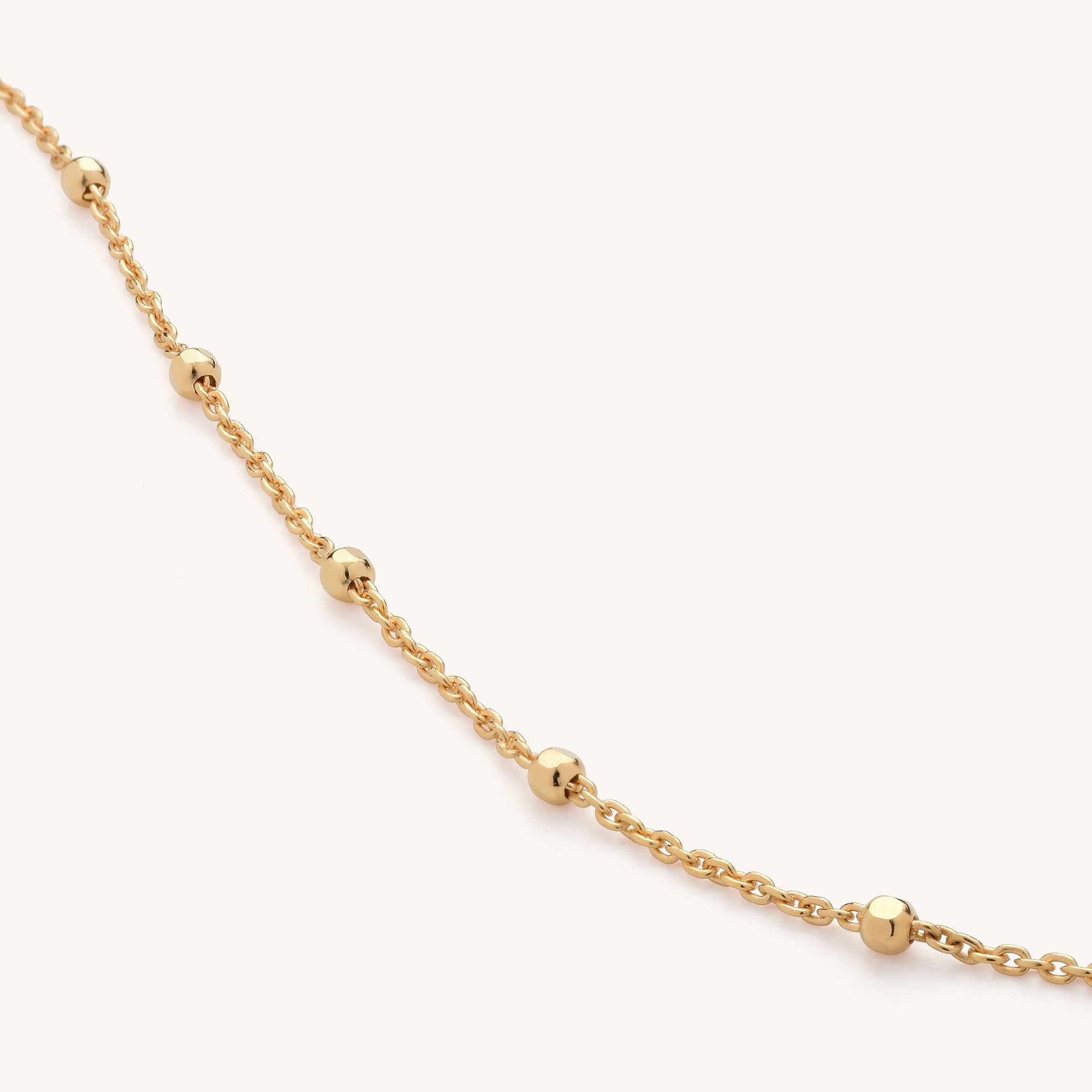 The Satellite Chain Gold is an elegant Eco Gold Plated necklace with evenly spaced small gold beads, showcased on a simple light background.