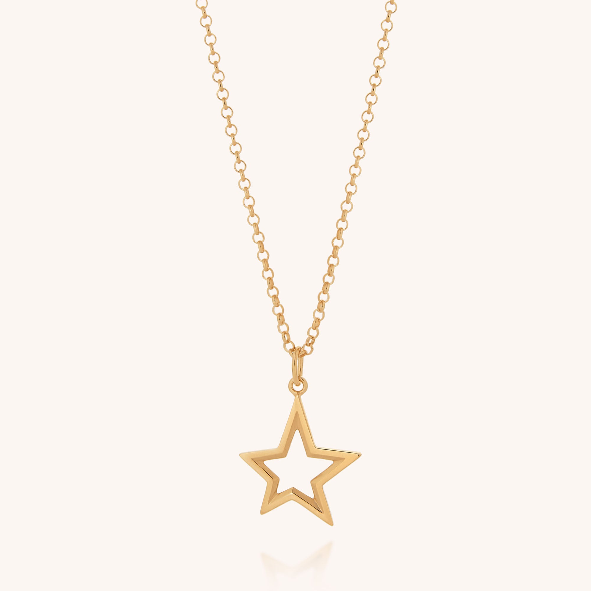 The Northern Star Necklace features a delicate gold chain with a hollow five-pointed star pendant, inspired by the celestial Northern Star, shining against a simple light background.
