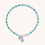 The Linear Birthstone Bracelet features alternating turquoise and silver beads, a silver clasp, and two charms—one engraved with N and another with a turquoise stone—making it perfect for gemstone jewellery lovers.