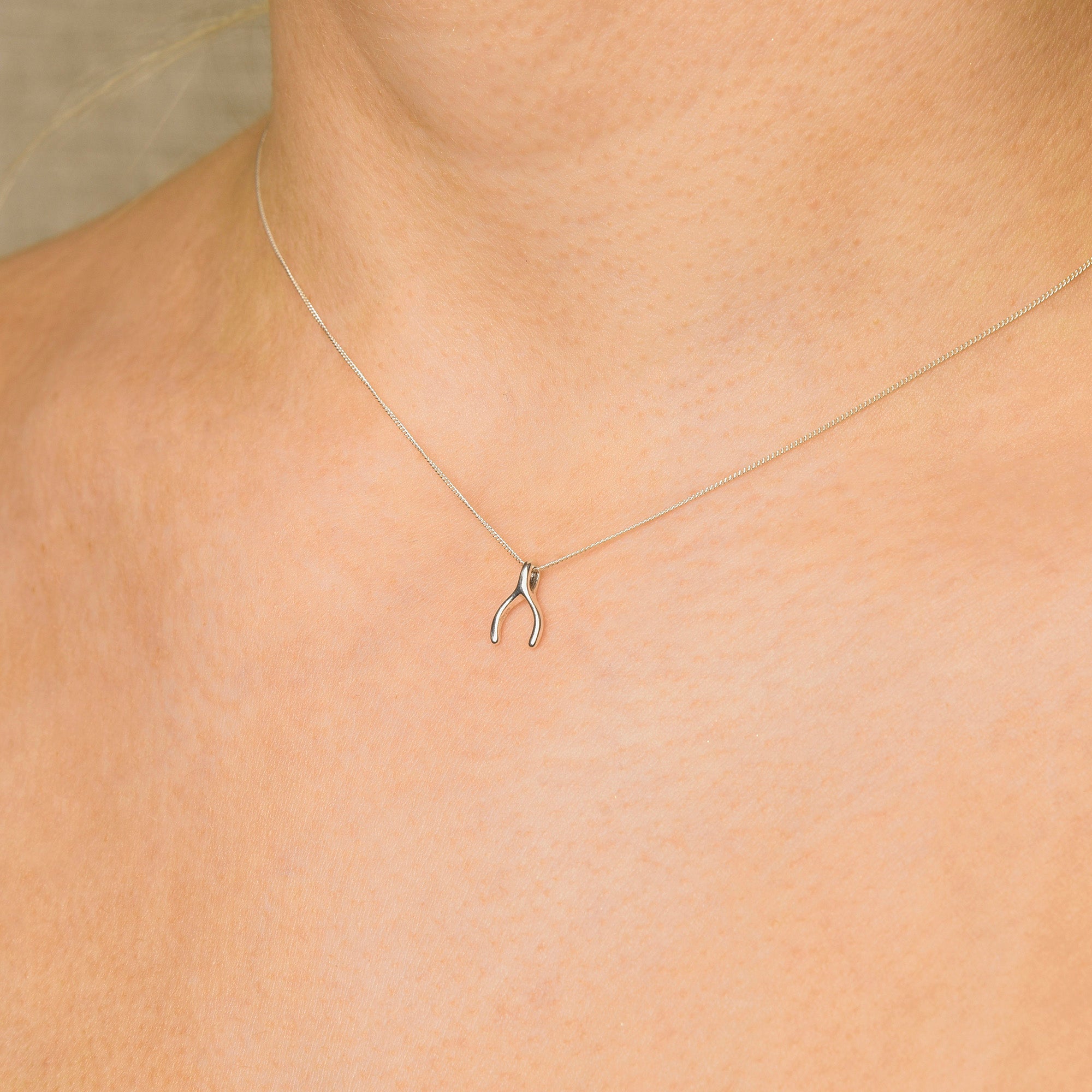 wishing bone necklace on a neck