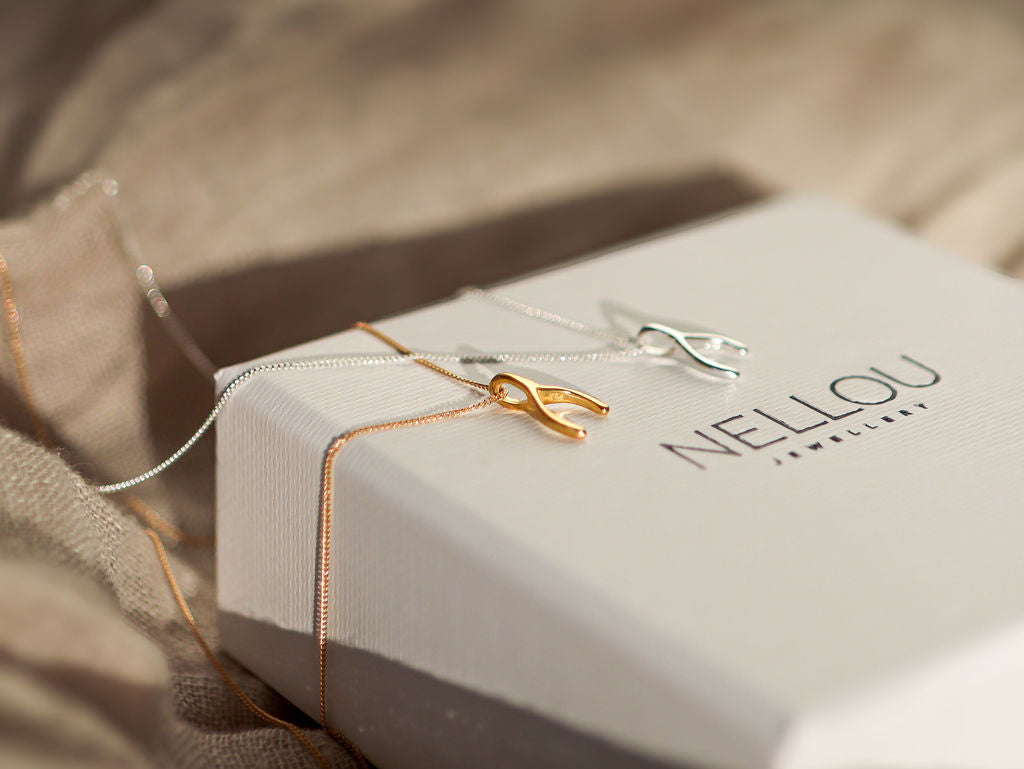 Two wishing bone necklace on a jewellery box