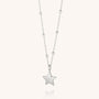 The Star Charm Necklace, an eco-friendly piece from our celestial-inspired collection, features a polished silver star pendant on a beaded chain with round accents, showcased on a light neutral background.