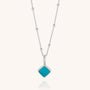 The Diamond Birthstone Necklace December features a delicate silver chain with small beads and a square turquoise gemstone pendant set in a silver frame.