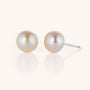 The Large Pearl Button Stud Earrings feature elegant pearl studs with silver posts, displayed on a simple, light background—perfect as a sophisticated statement piece for any jewelry collection.