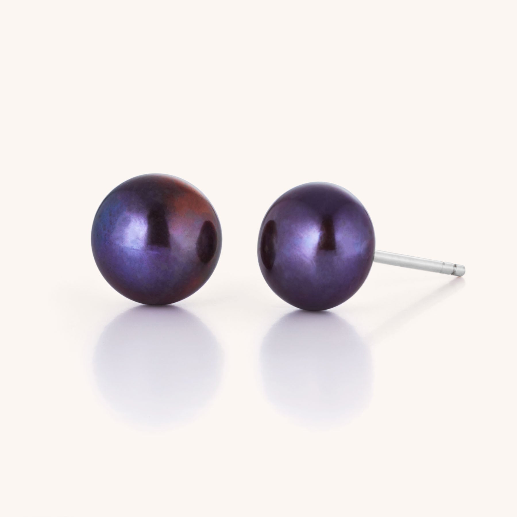 Large Pearl Button Stud Earrings feature round, iridescent purple pearls on silver posts, shown against a clean white background—ideal for adding a touch of sophisticated style to any outfit.