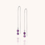 A pair of Fall Earrings Birthstone February silver threader earrings with delicate chains, each ending in two small round amethyst beads, displayed on a light background.